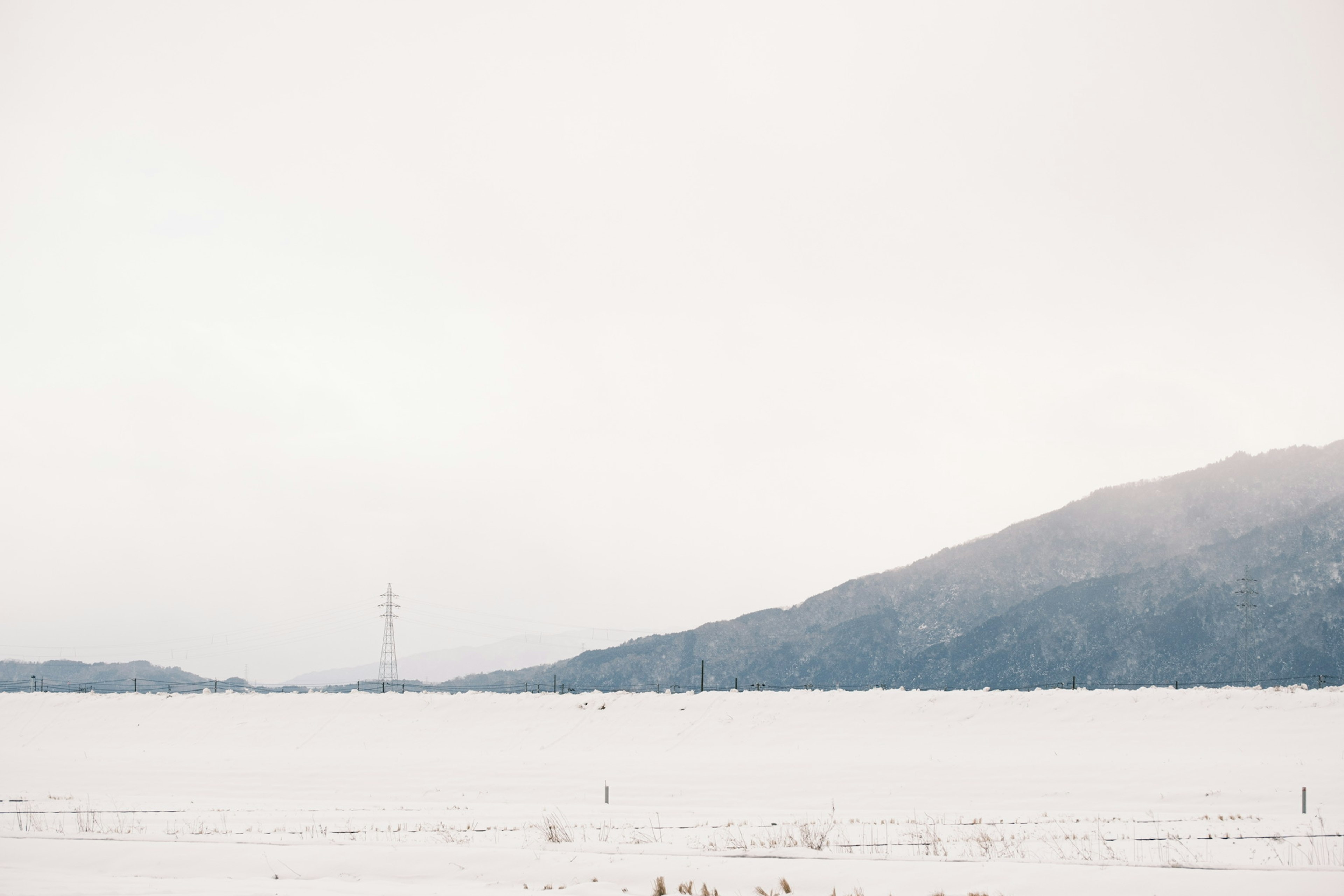 Snow-covered landscape with distant mountains