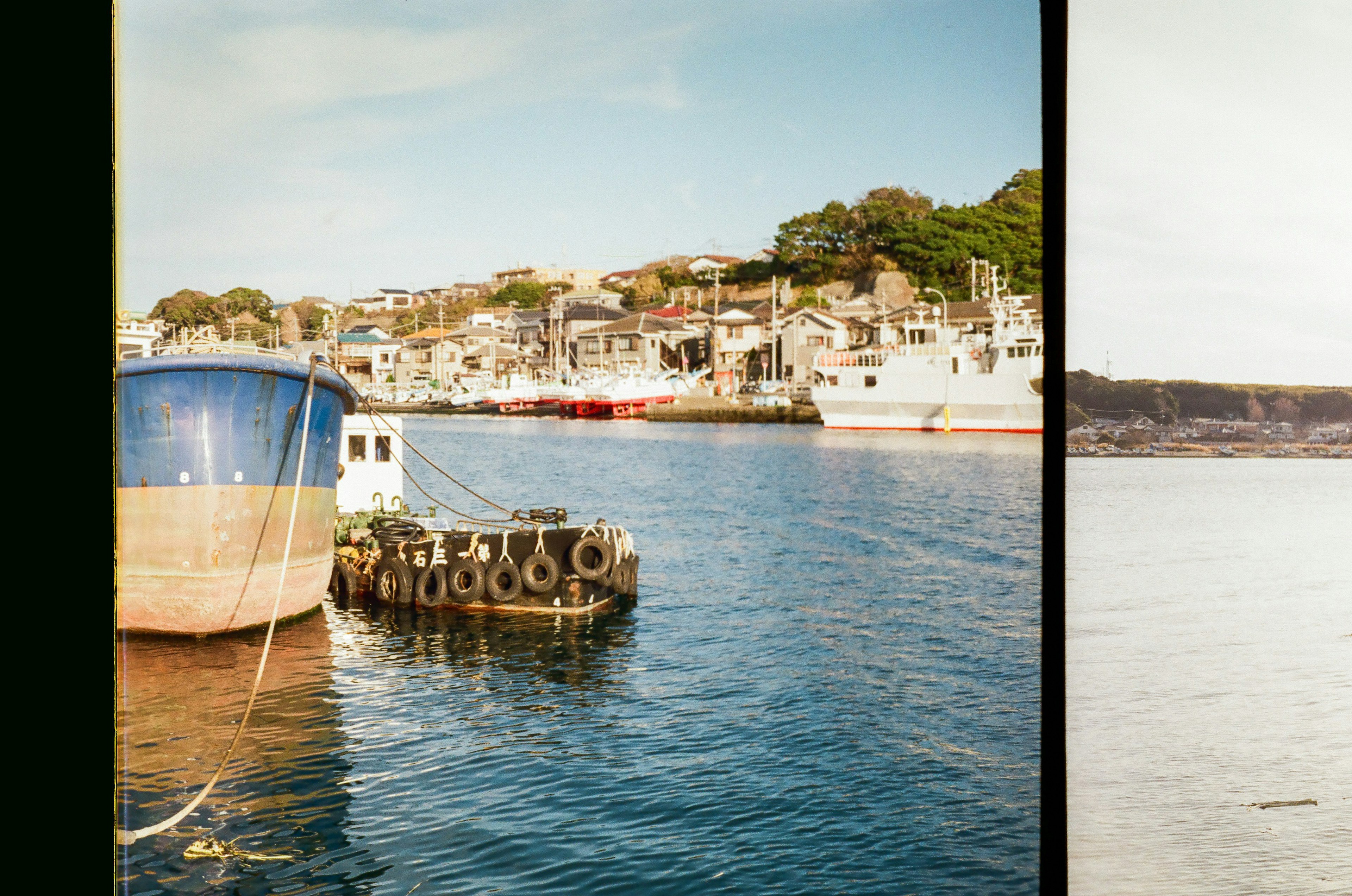 A picturesque view of a boat docked at a harbor with surrounding buildings