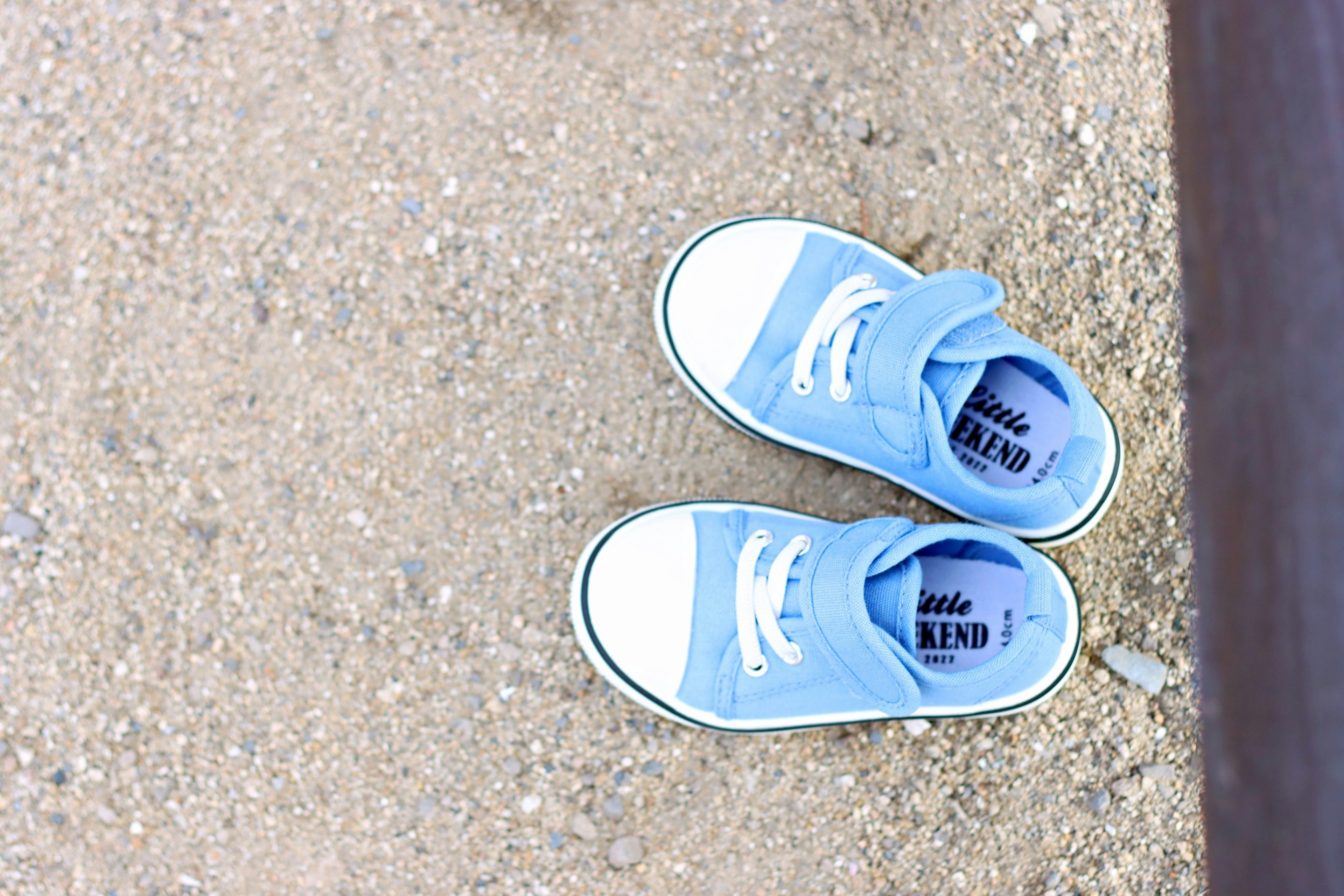 Blue sneakers placed on the ground