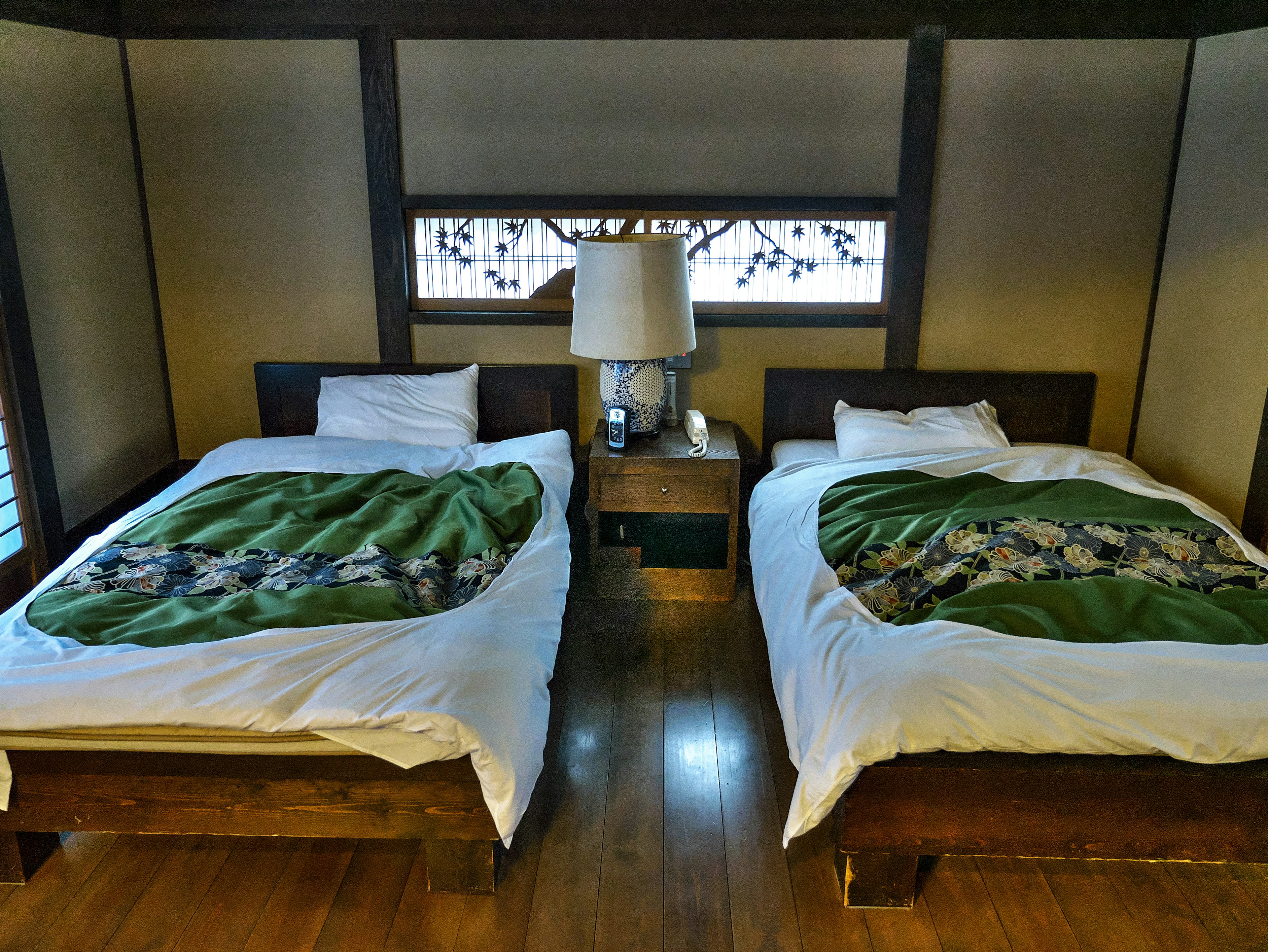 Japanese style bedroom with two beds and a lamp