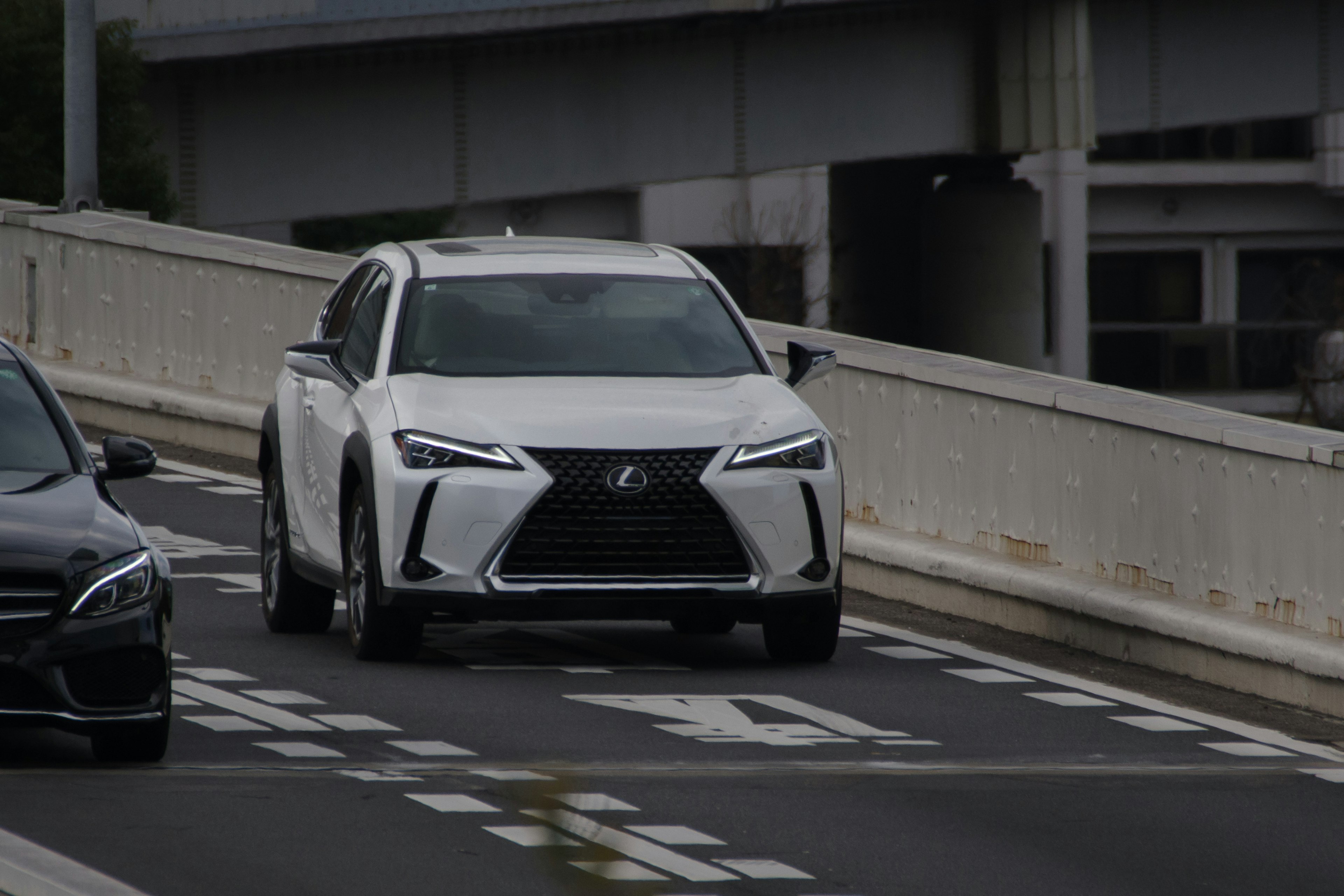 White Lexus SUV driving on the road