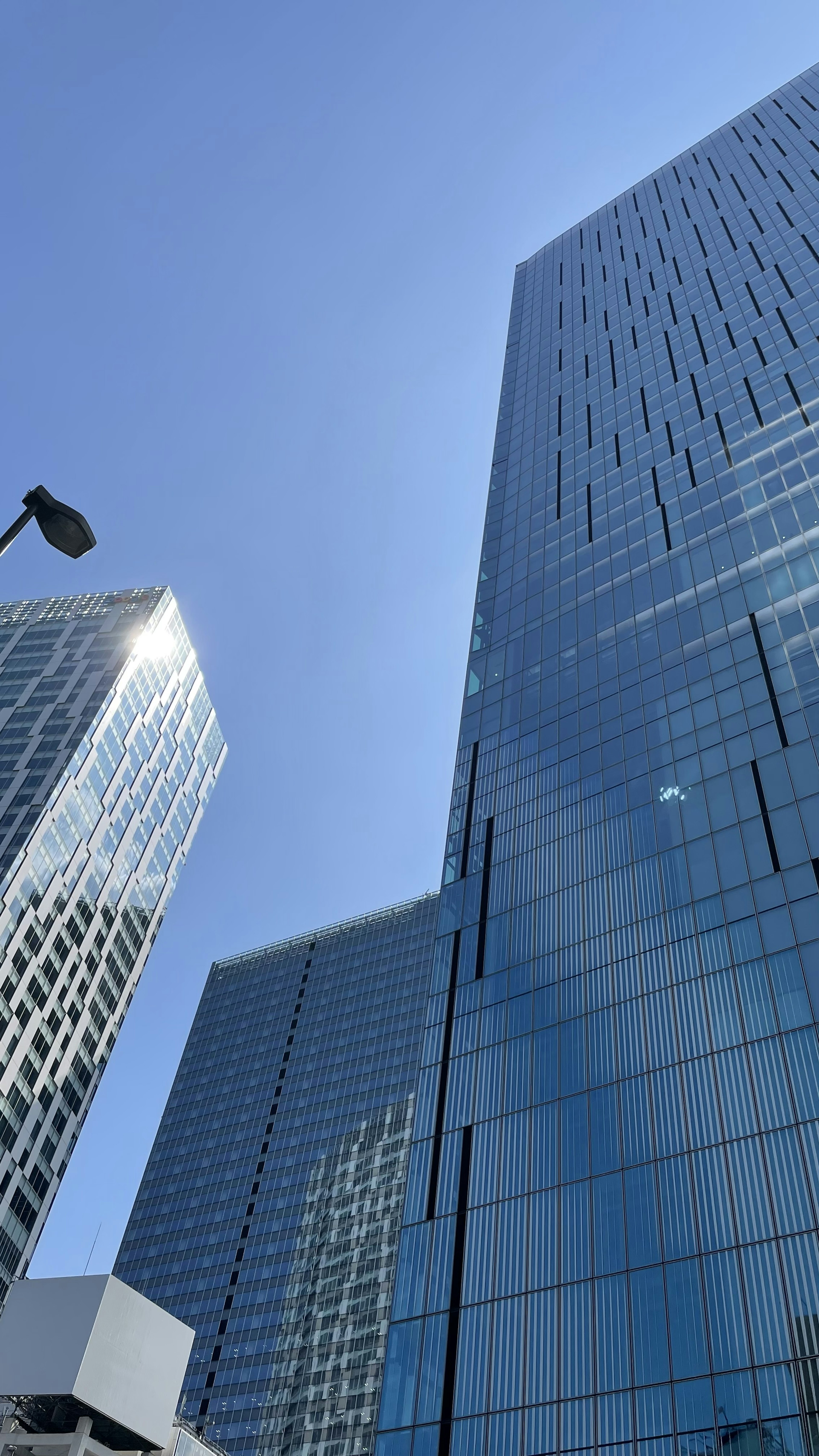 Skyscrapers with glass facades against a clear blue sky