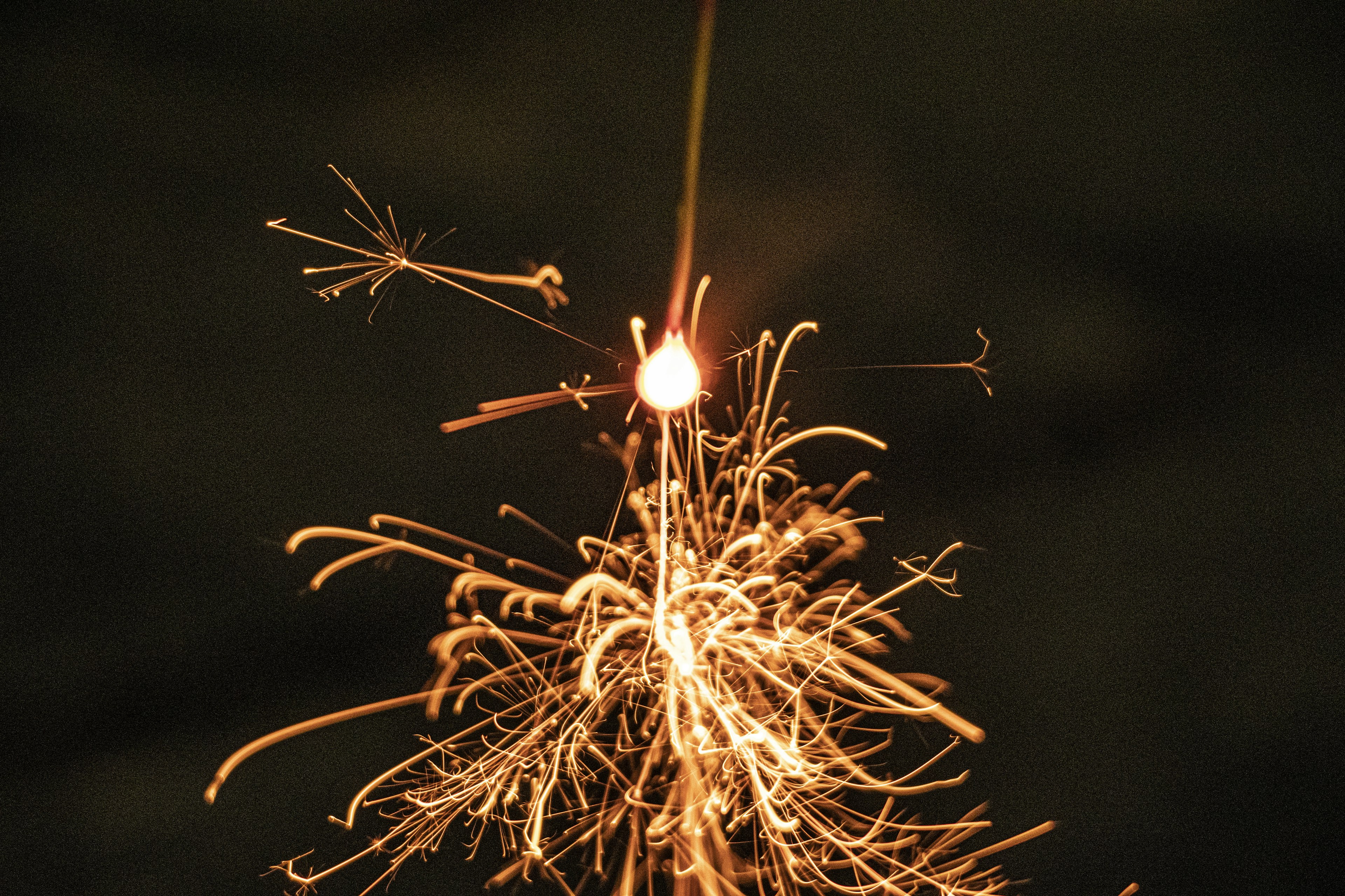 Sparkler emitting bright sparks in the dark