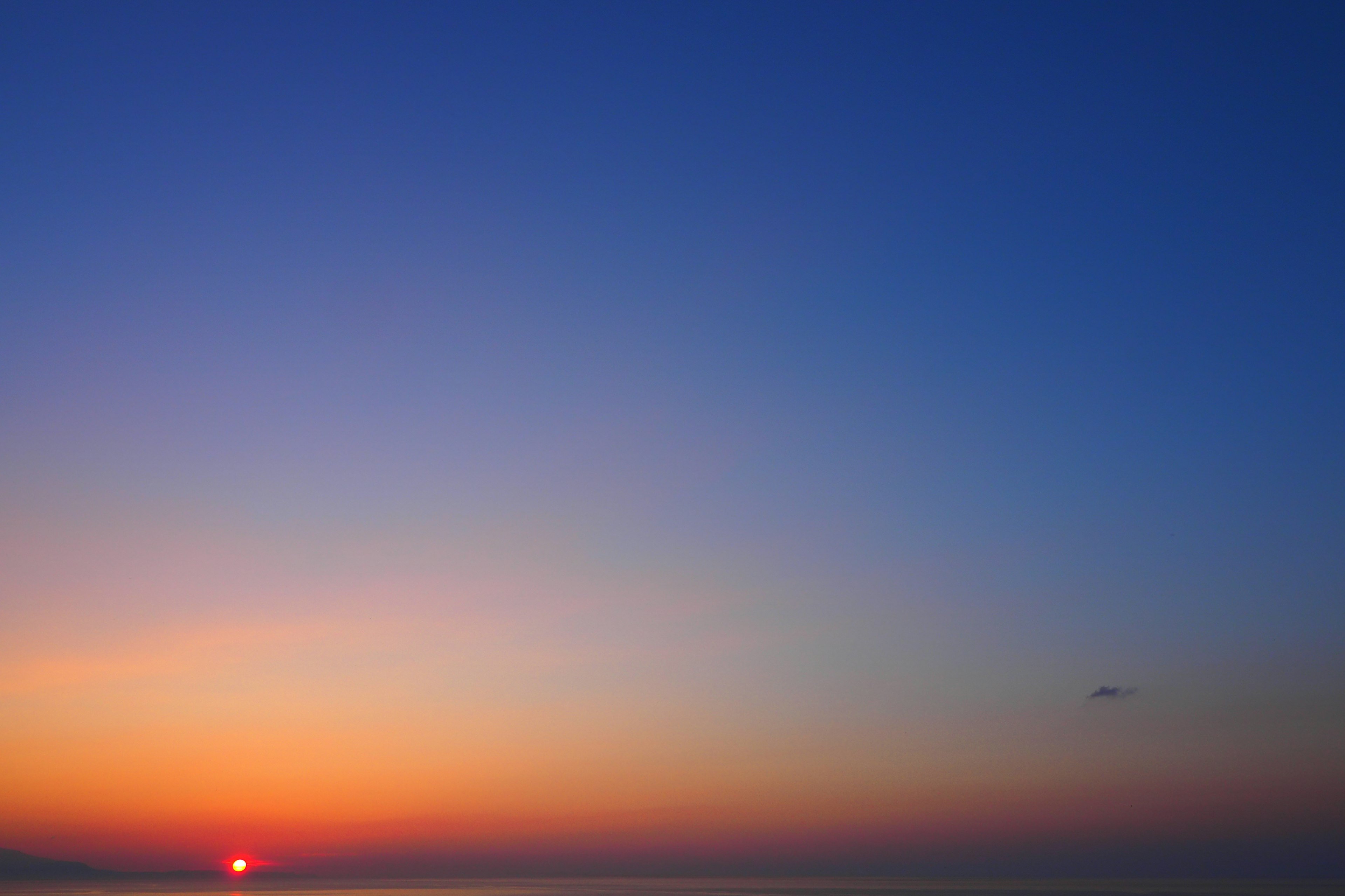 Beautiful gradient sky at sunset with an airplane