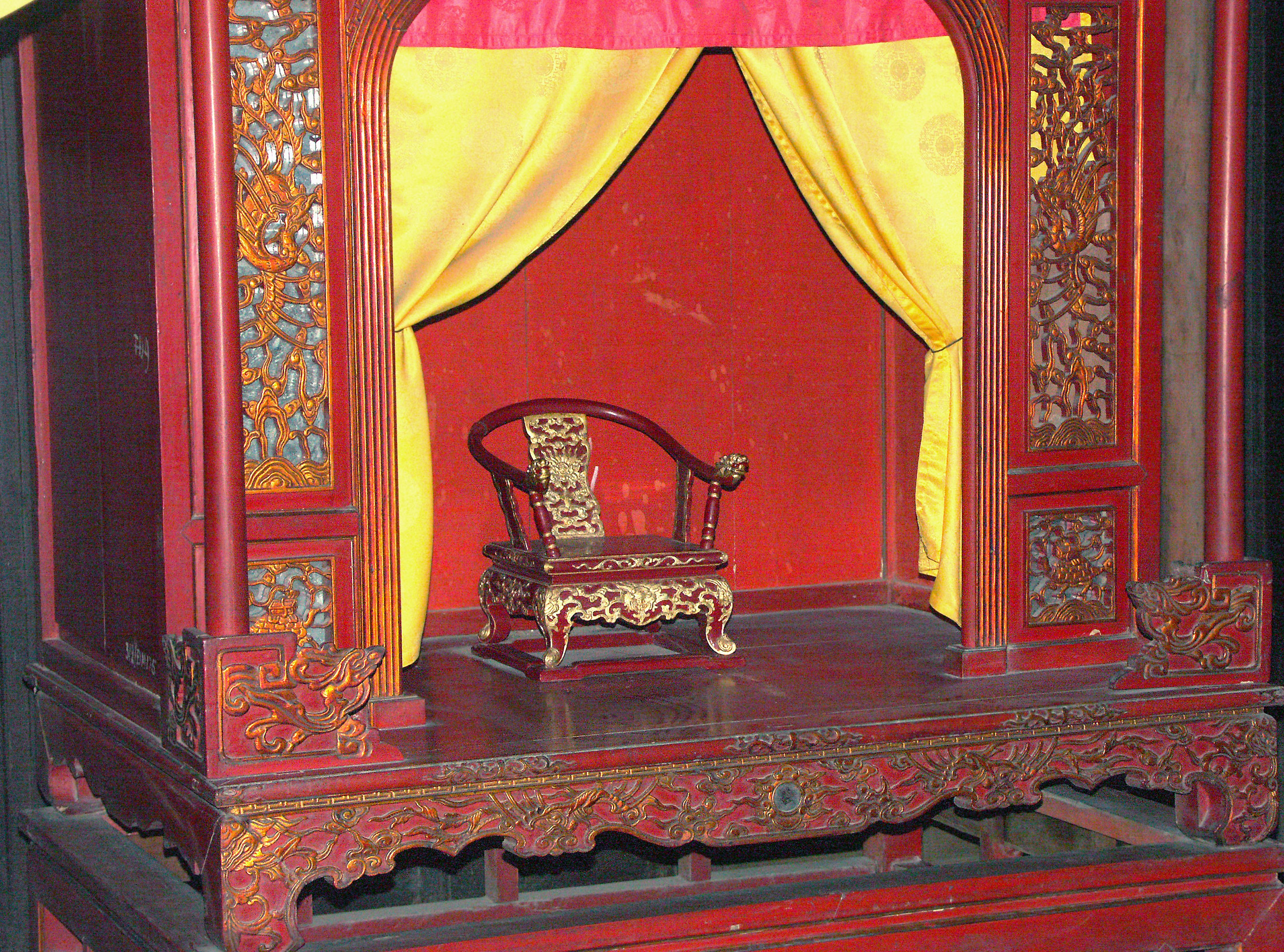 Traditional stage with decorative chair and red yellow curtains