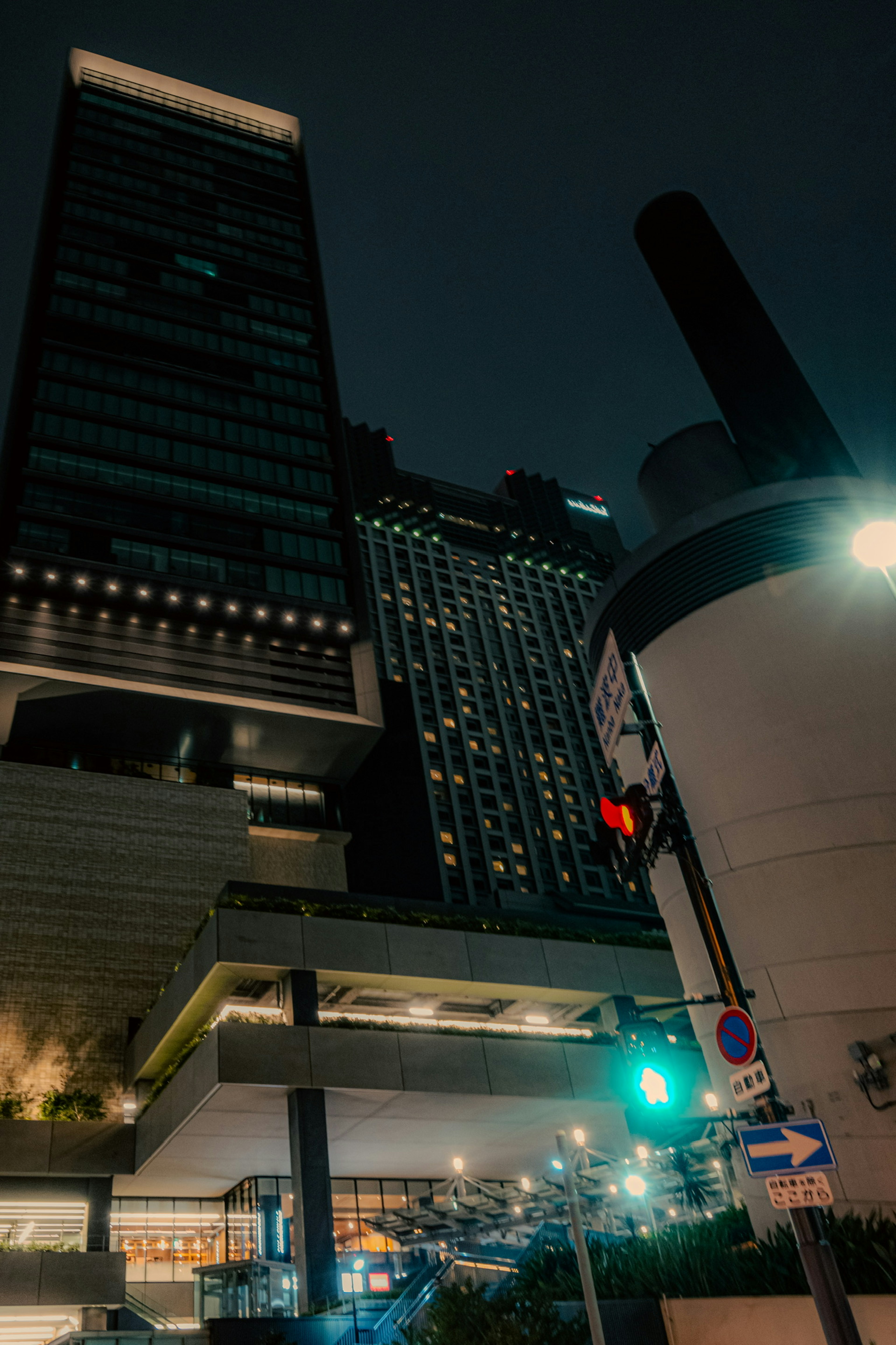 Urban landscape featuring skyscrapers and traffic lights at night