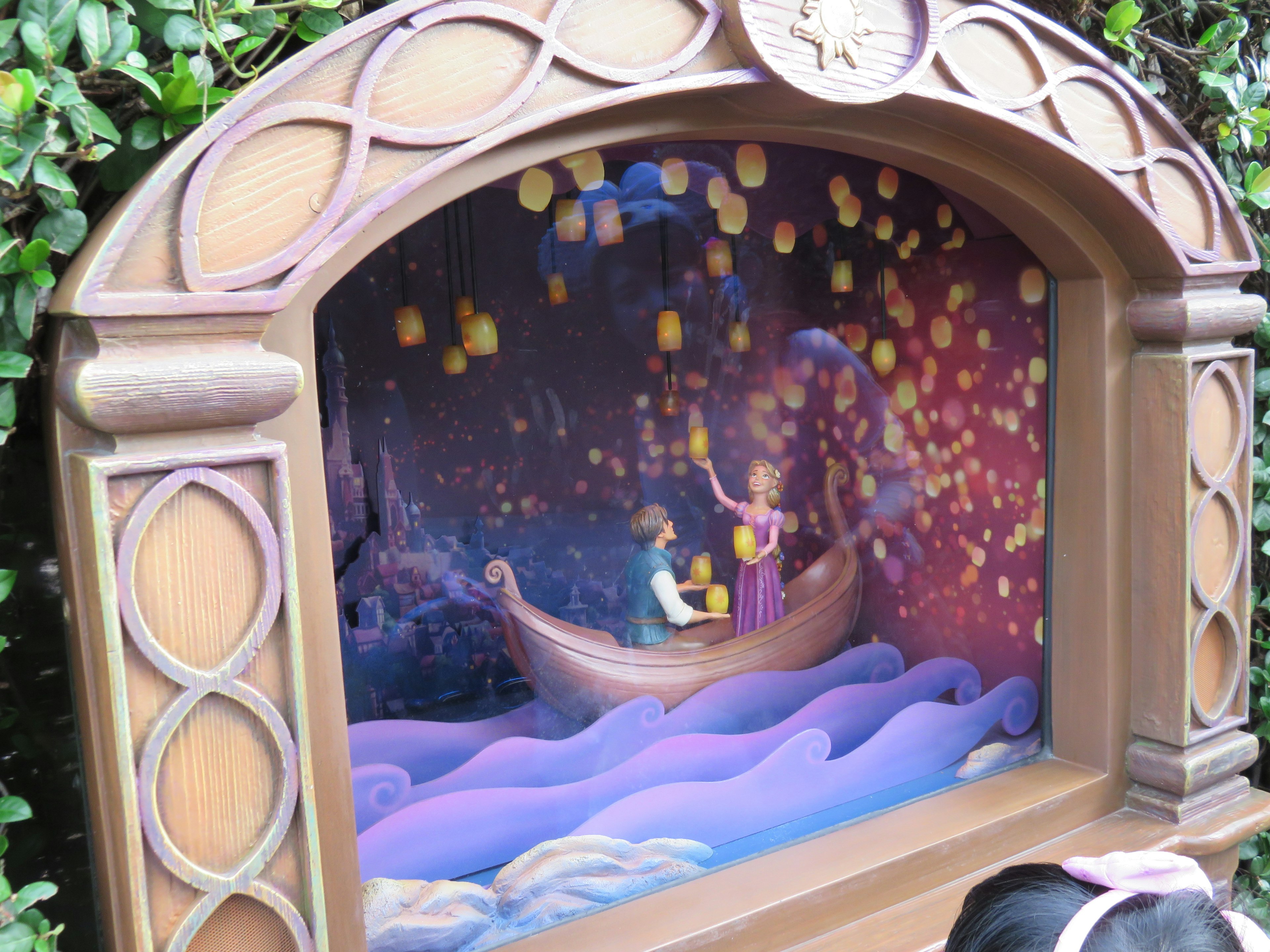 Display of characters in a boat under a night sky filled with floating lanterns