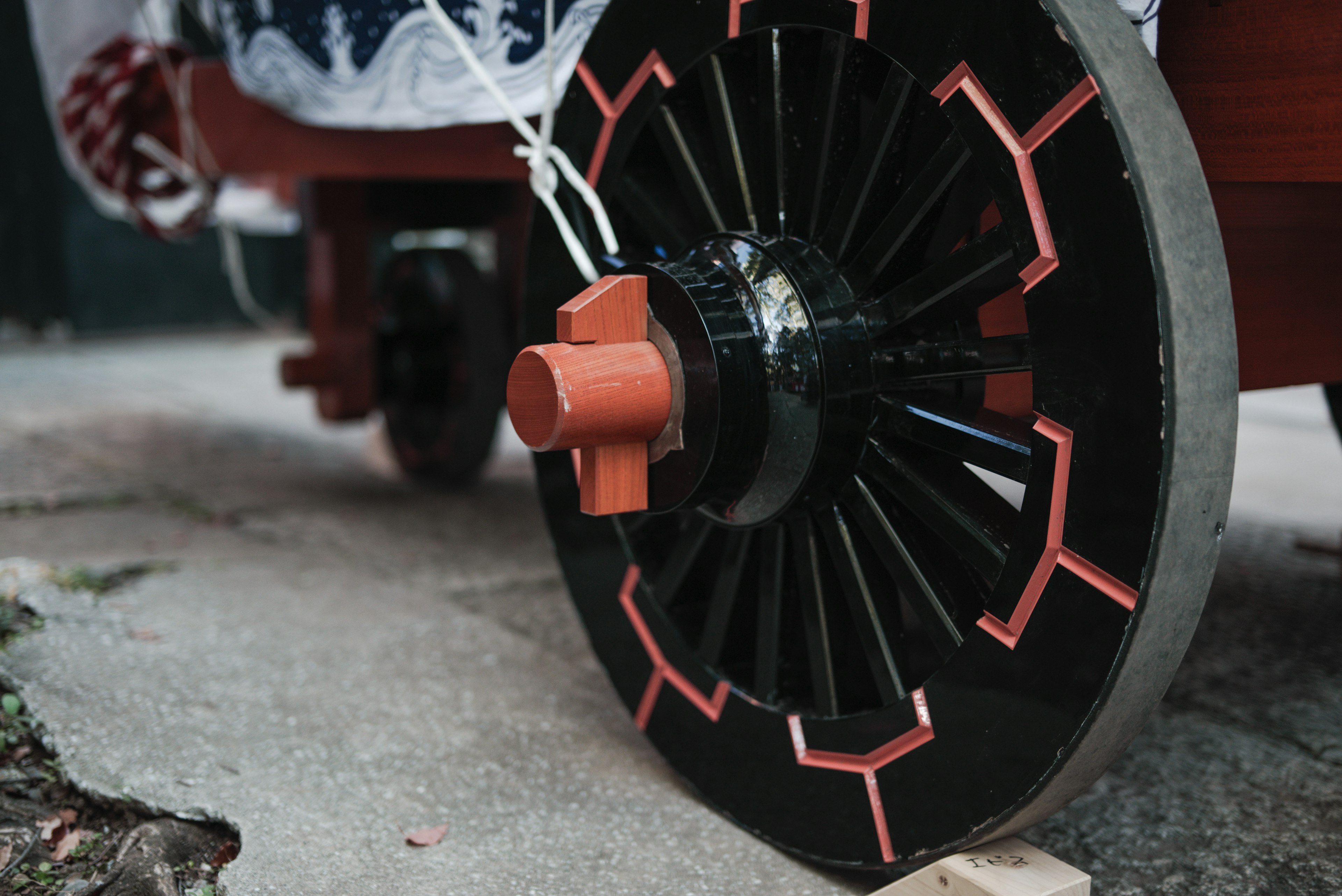 Close-up of a black and orange decorative wheel