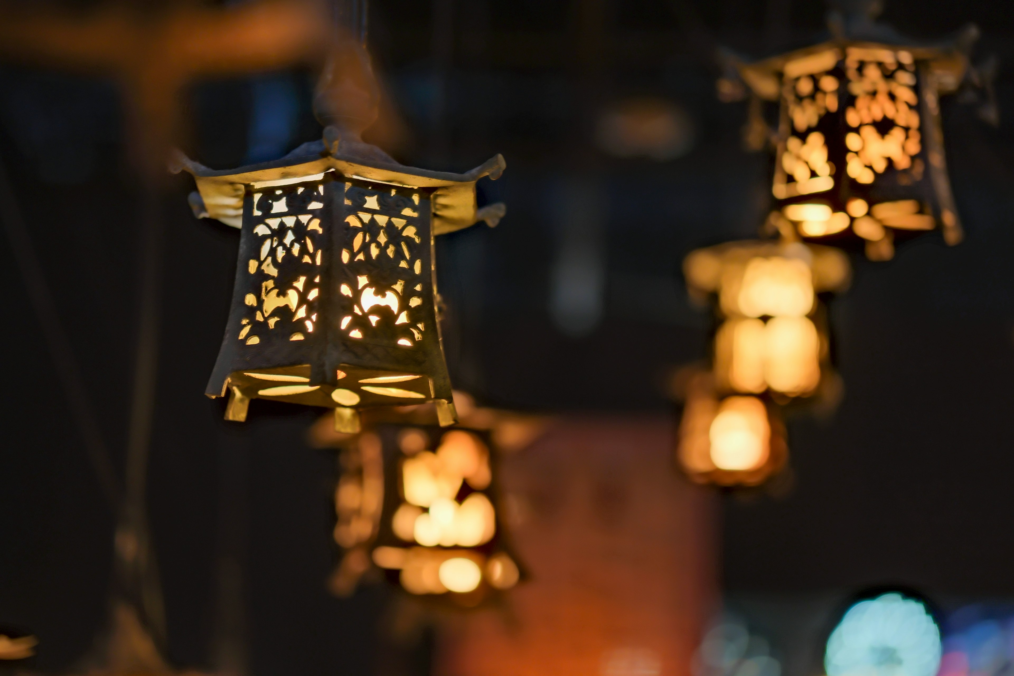 Decorative lanterns glowing softly against a dark background