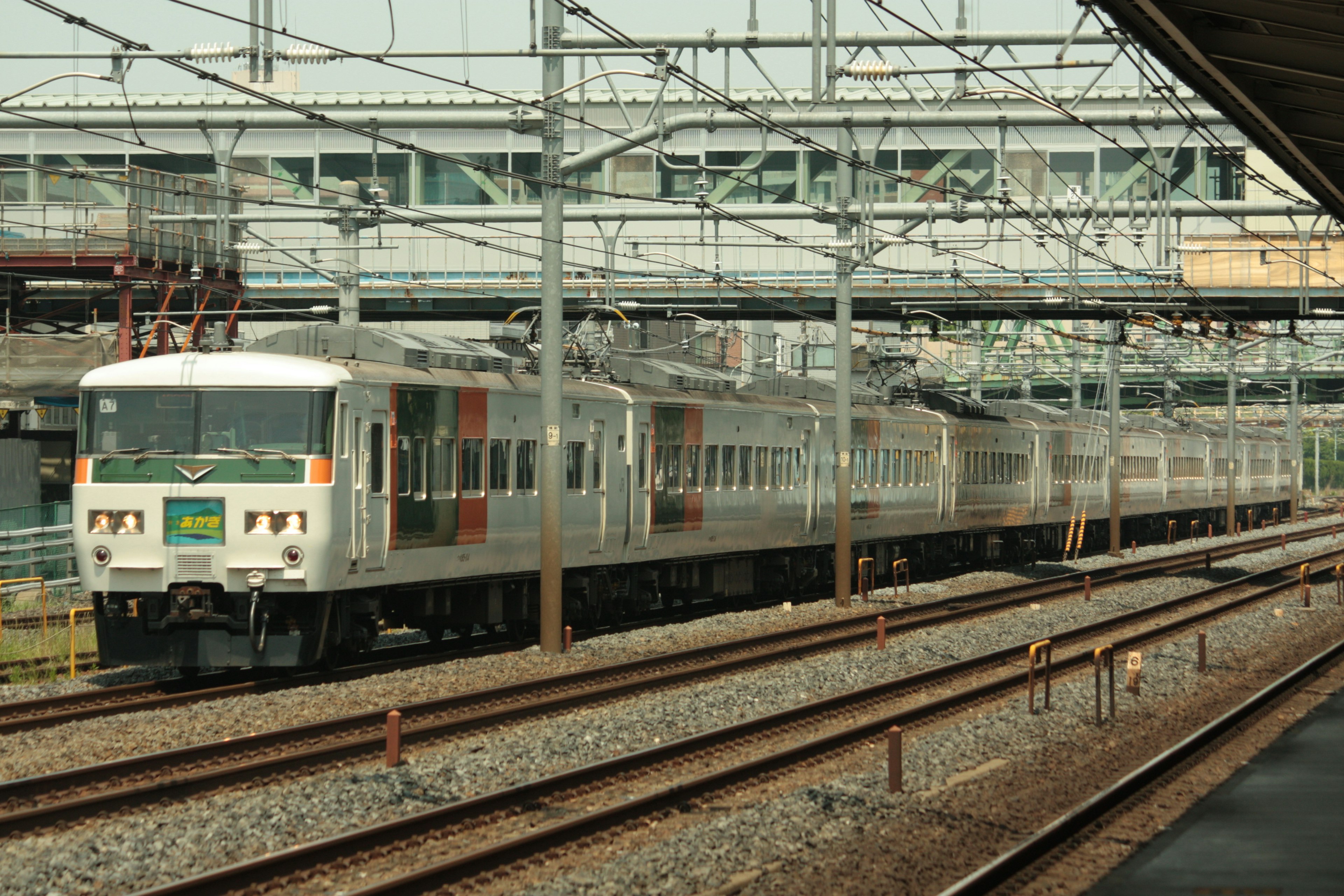 A train running on tracks in a station setting