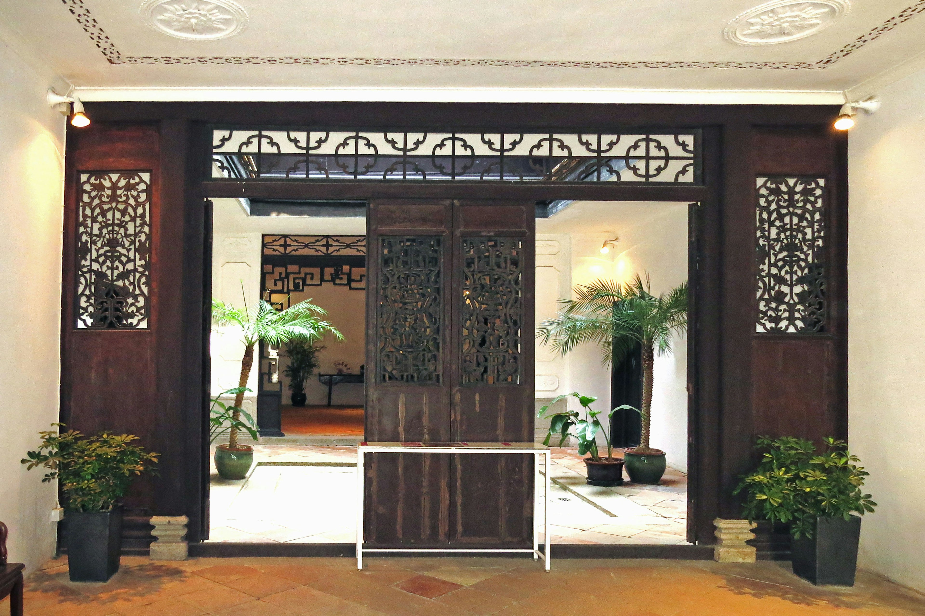 Entrance with traditional wooden doors and decorative panels