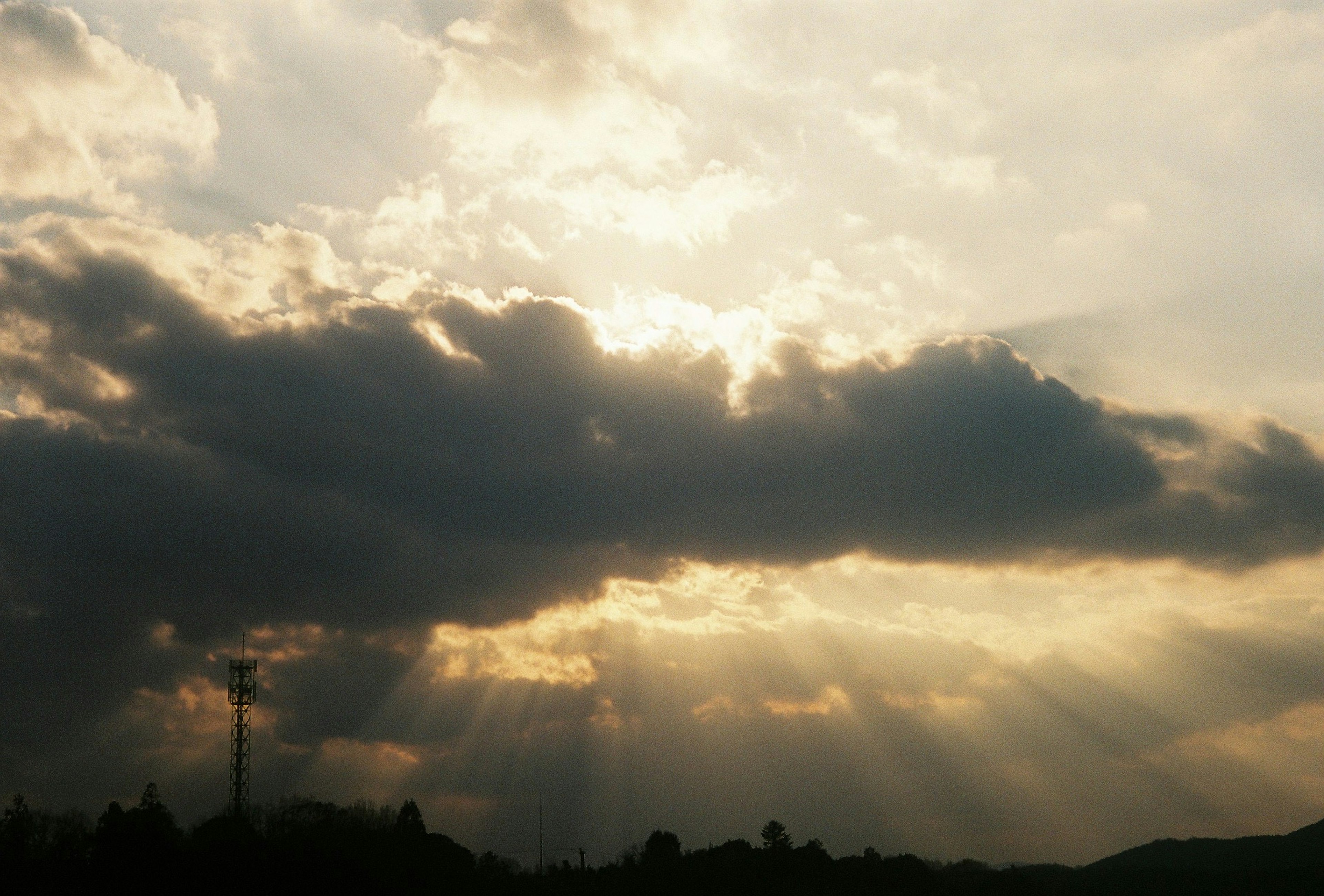 Beautiful sky with rays of light shining through clouds