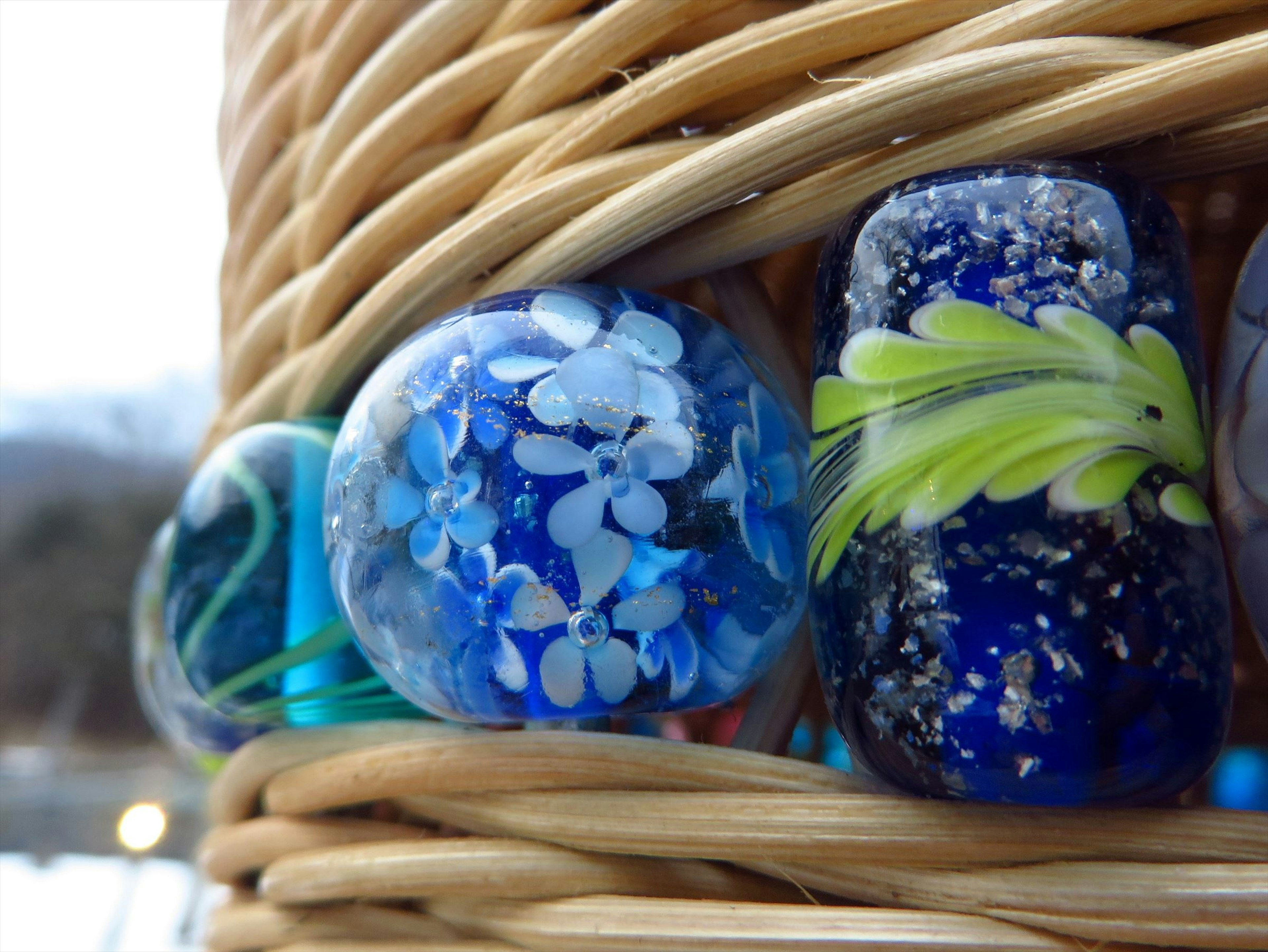 Beautiful beads featuring blue glass and white floral designs