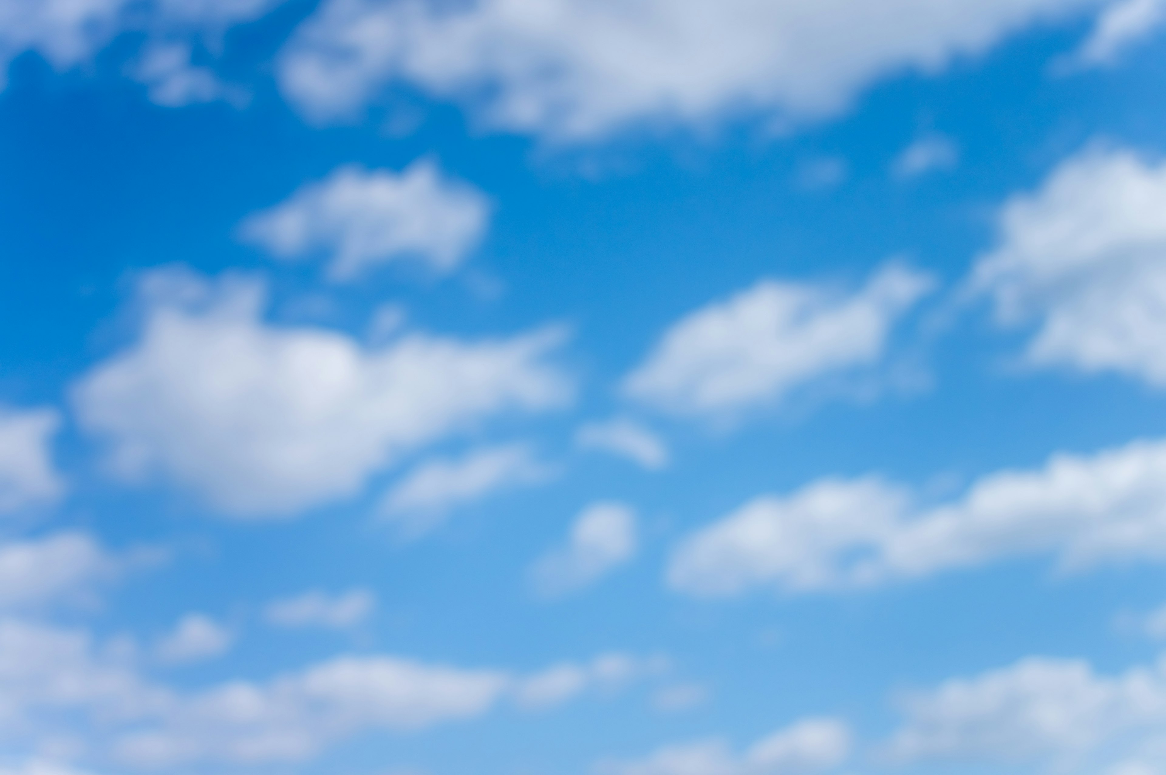 A landscape of white clouds floating in a blue sky