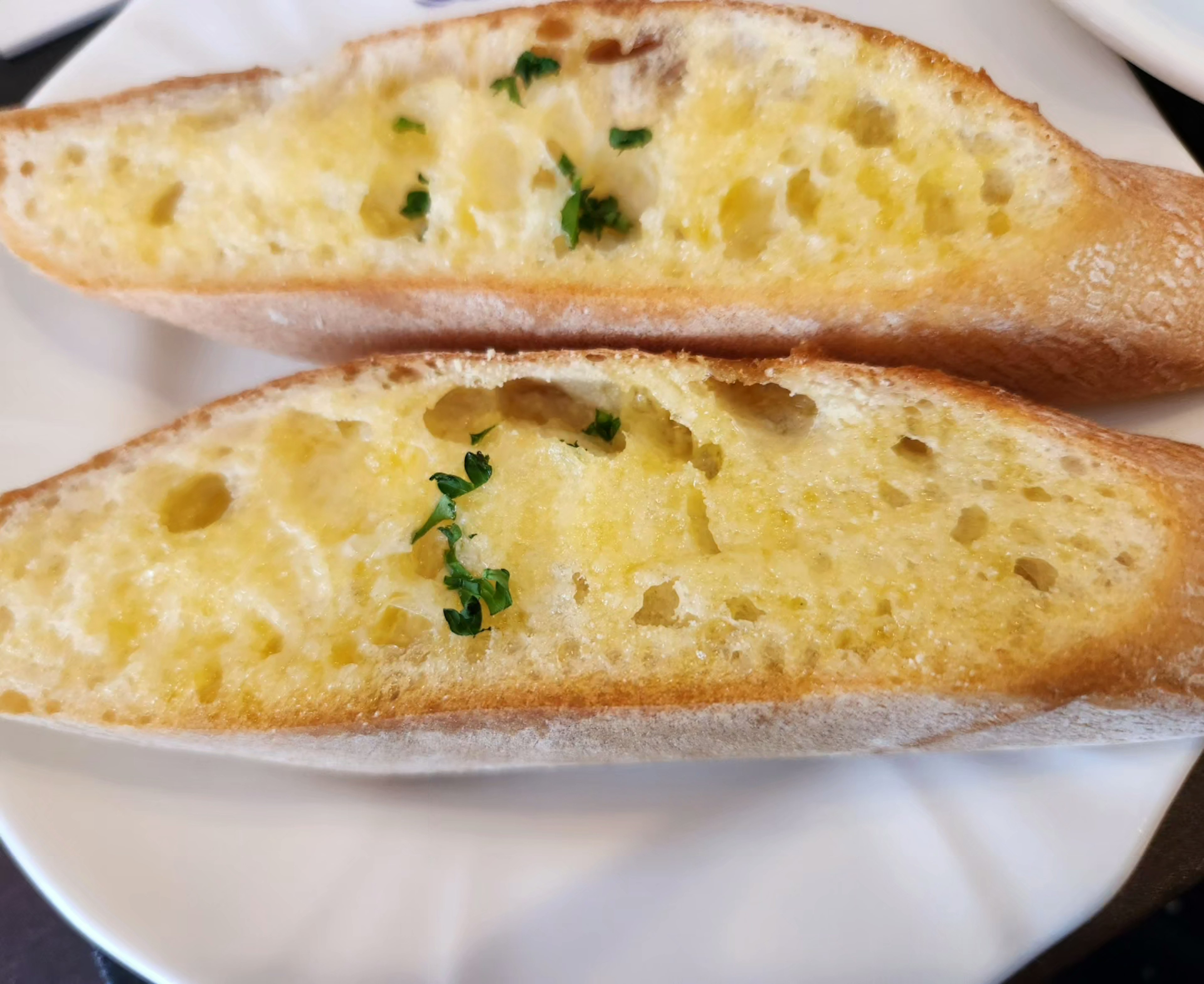 Image of cheese bread cut in half on a plate