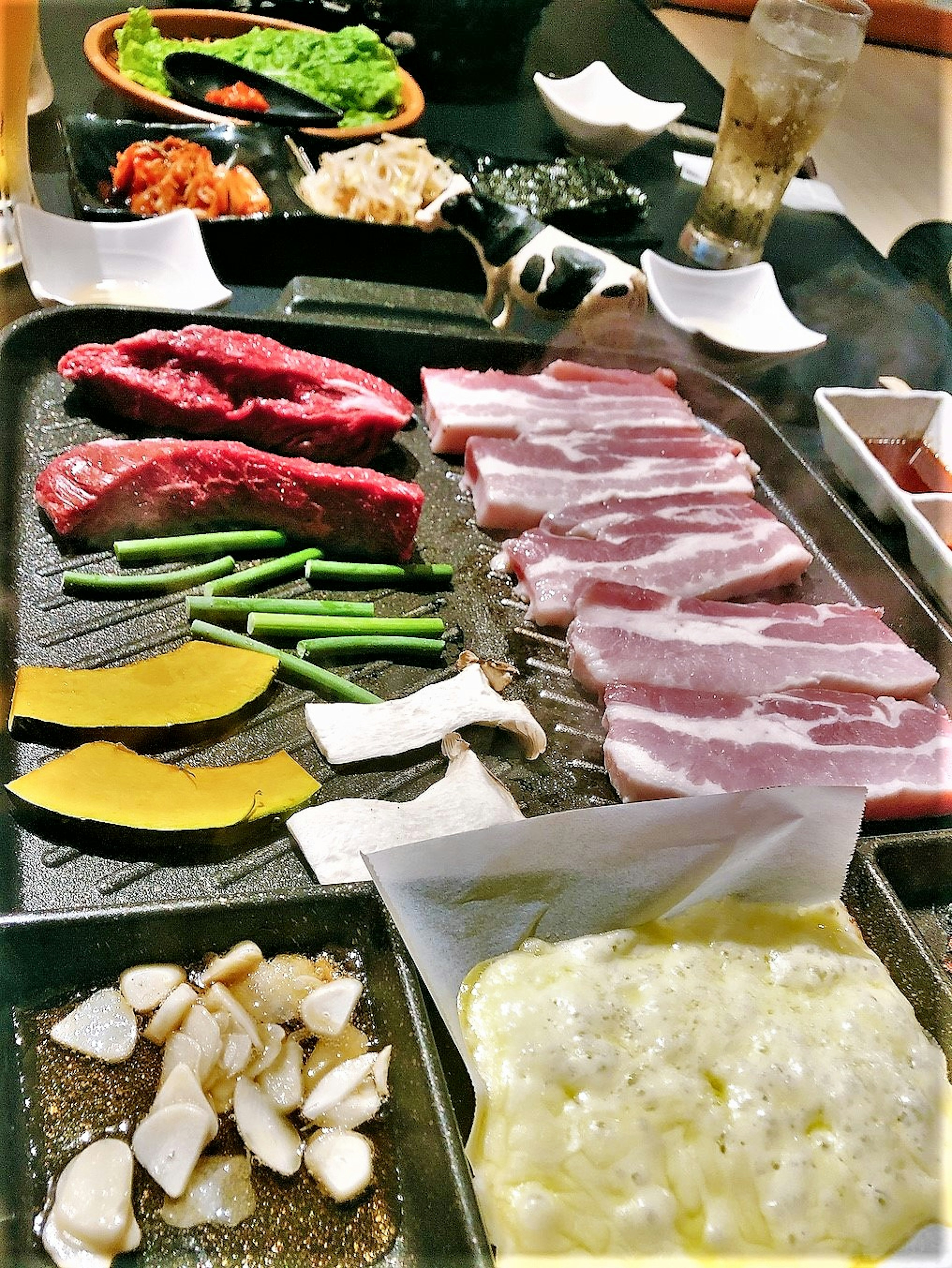 Grilled meat and vegetables arranged on a table