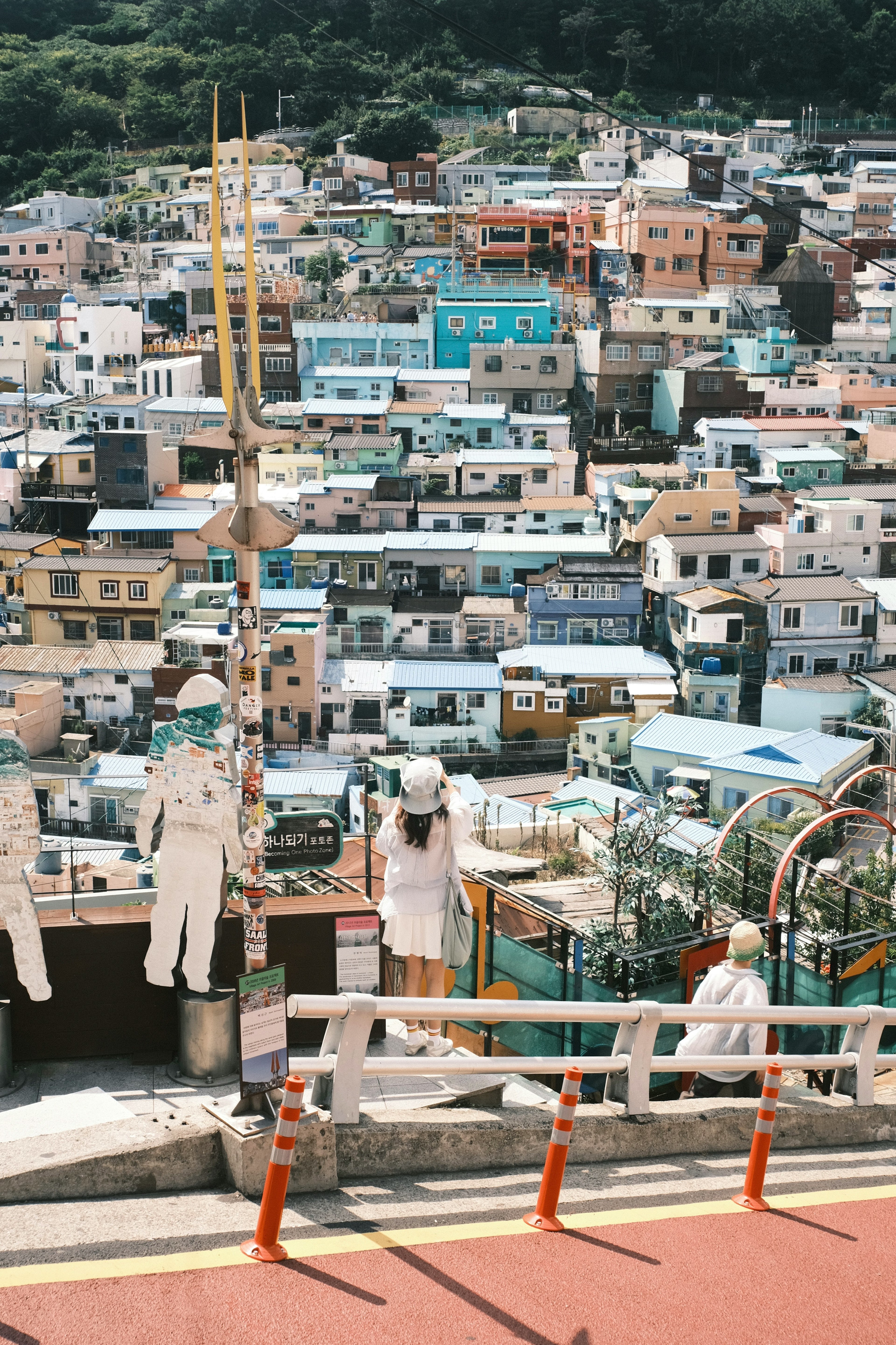 Colorful houses in a hillside view with people standing