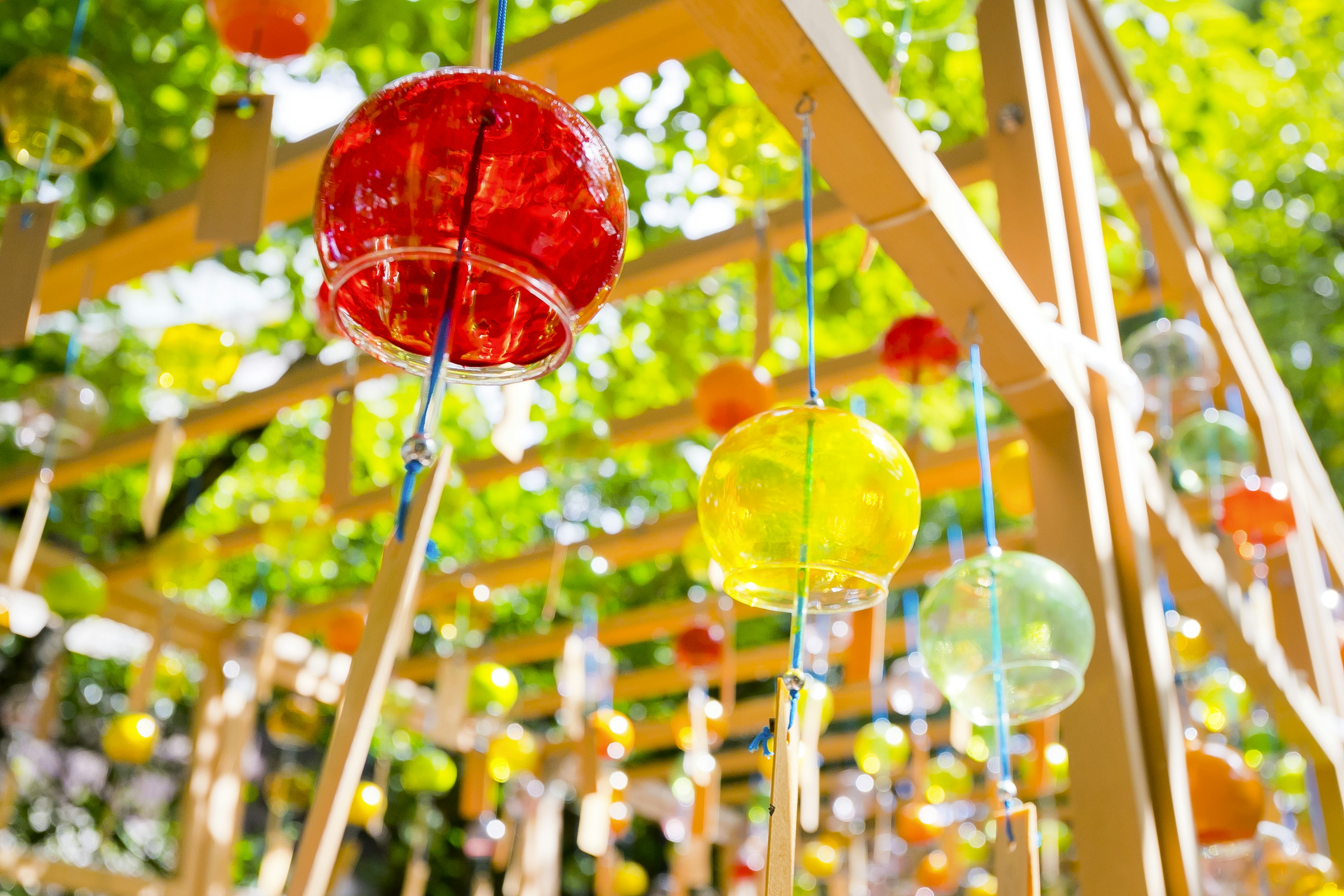 Bright outdoor scene with colorful wind chimes hanging