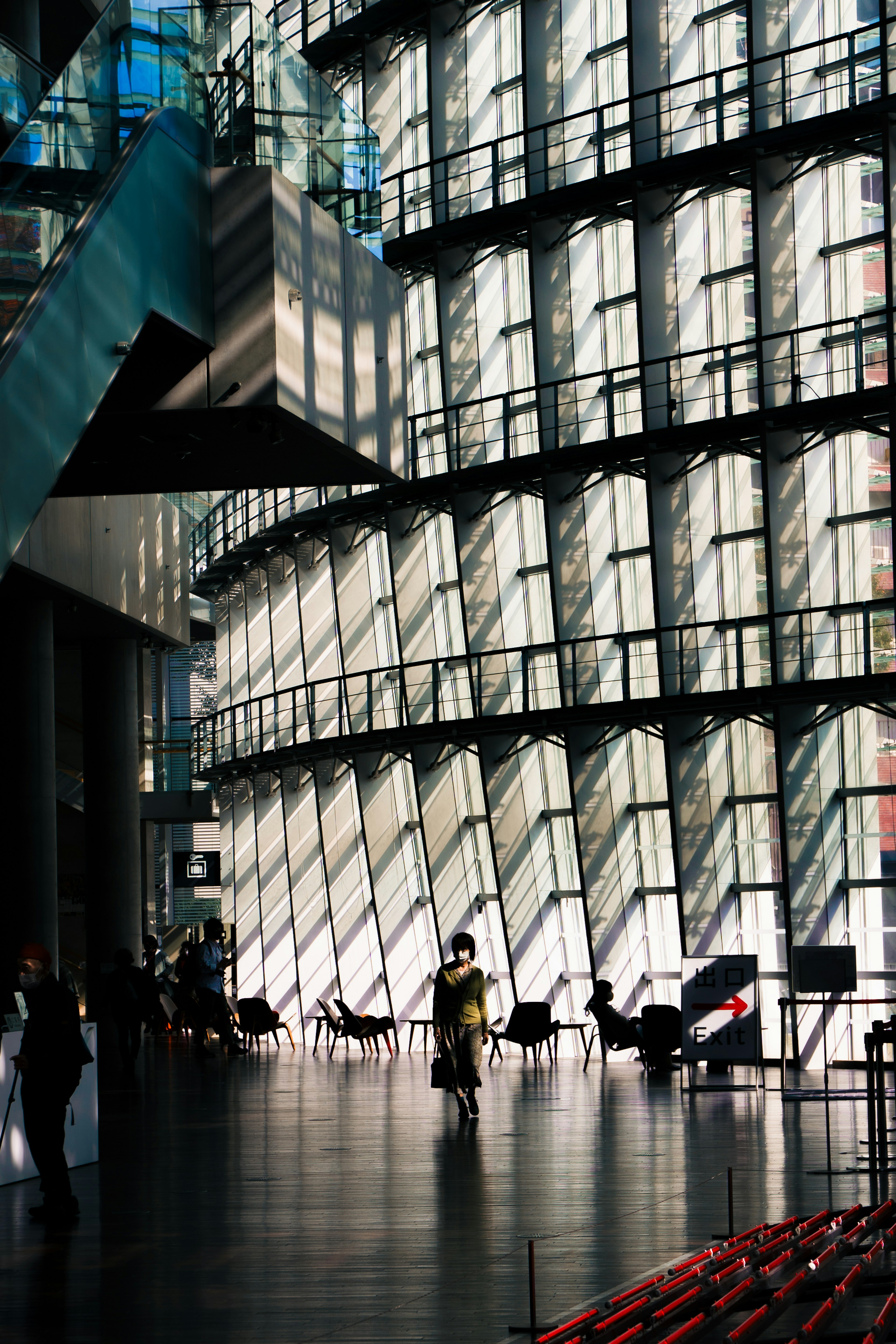 Interior of a modern building featuring large windows creating striking light and shadow patterns