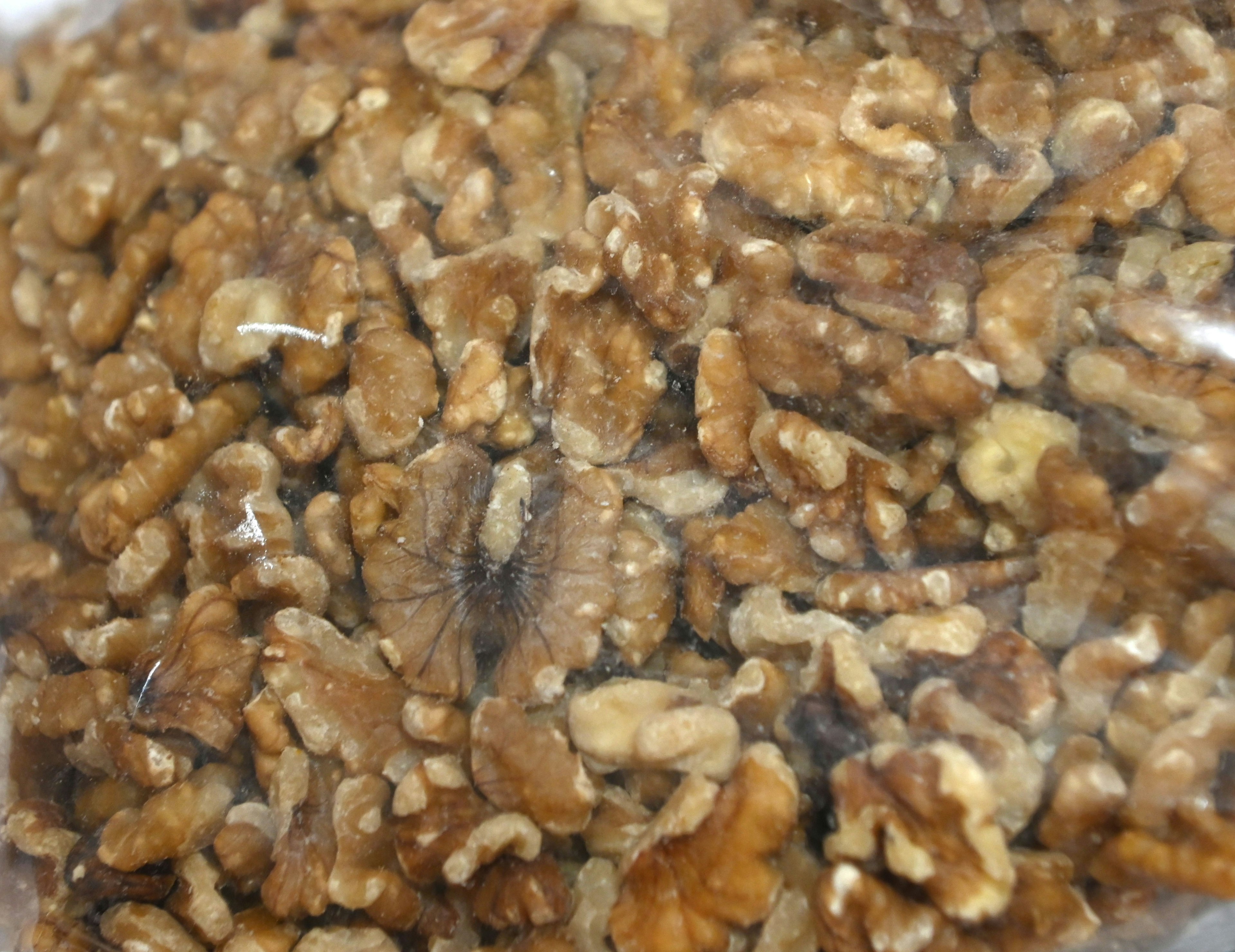 Close-up of broken walnuts in a transparent bag