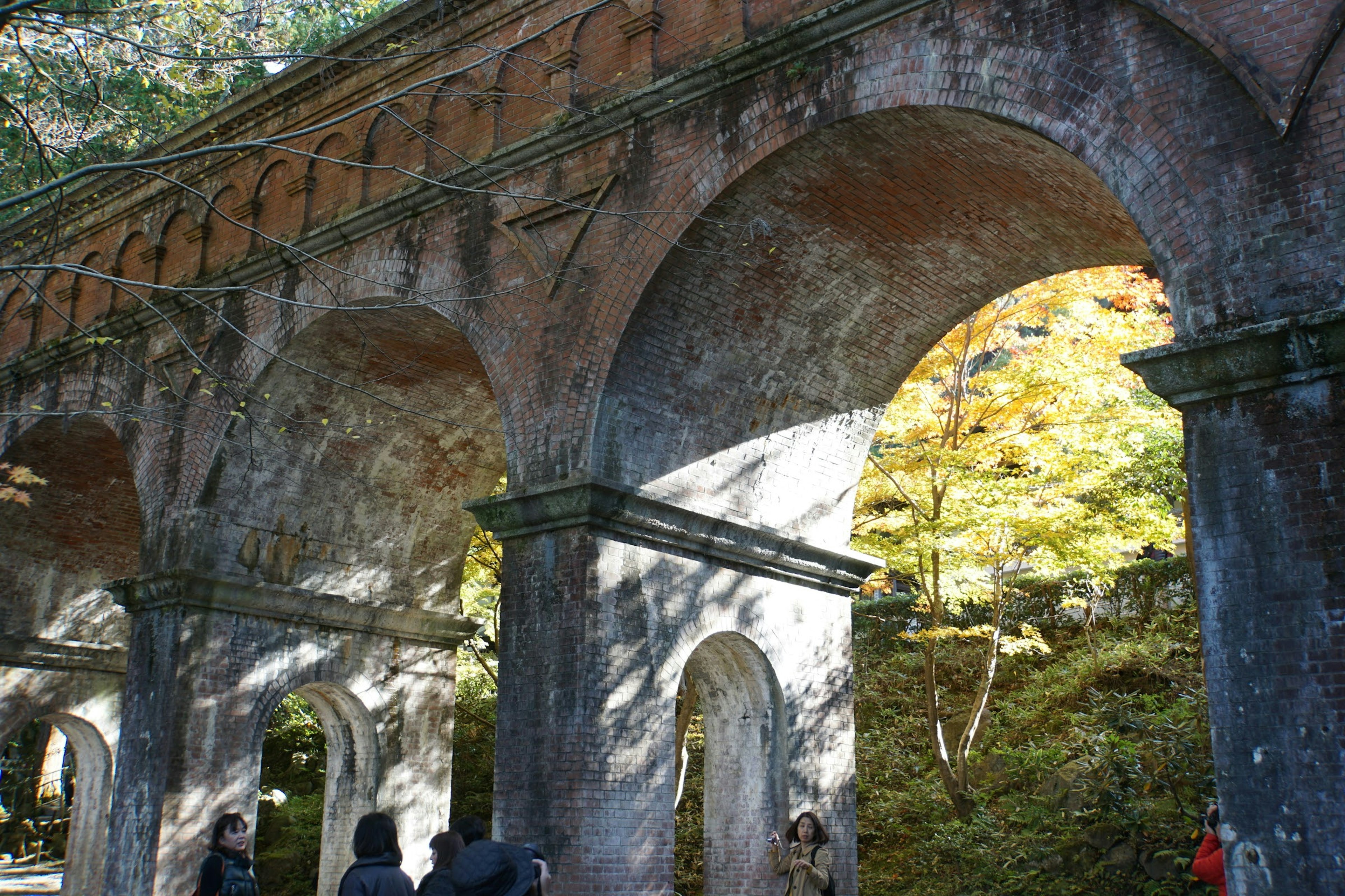 Ancient arch bridge structure surrounded by natural scenery