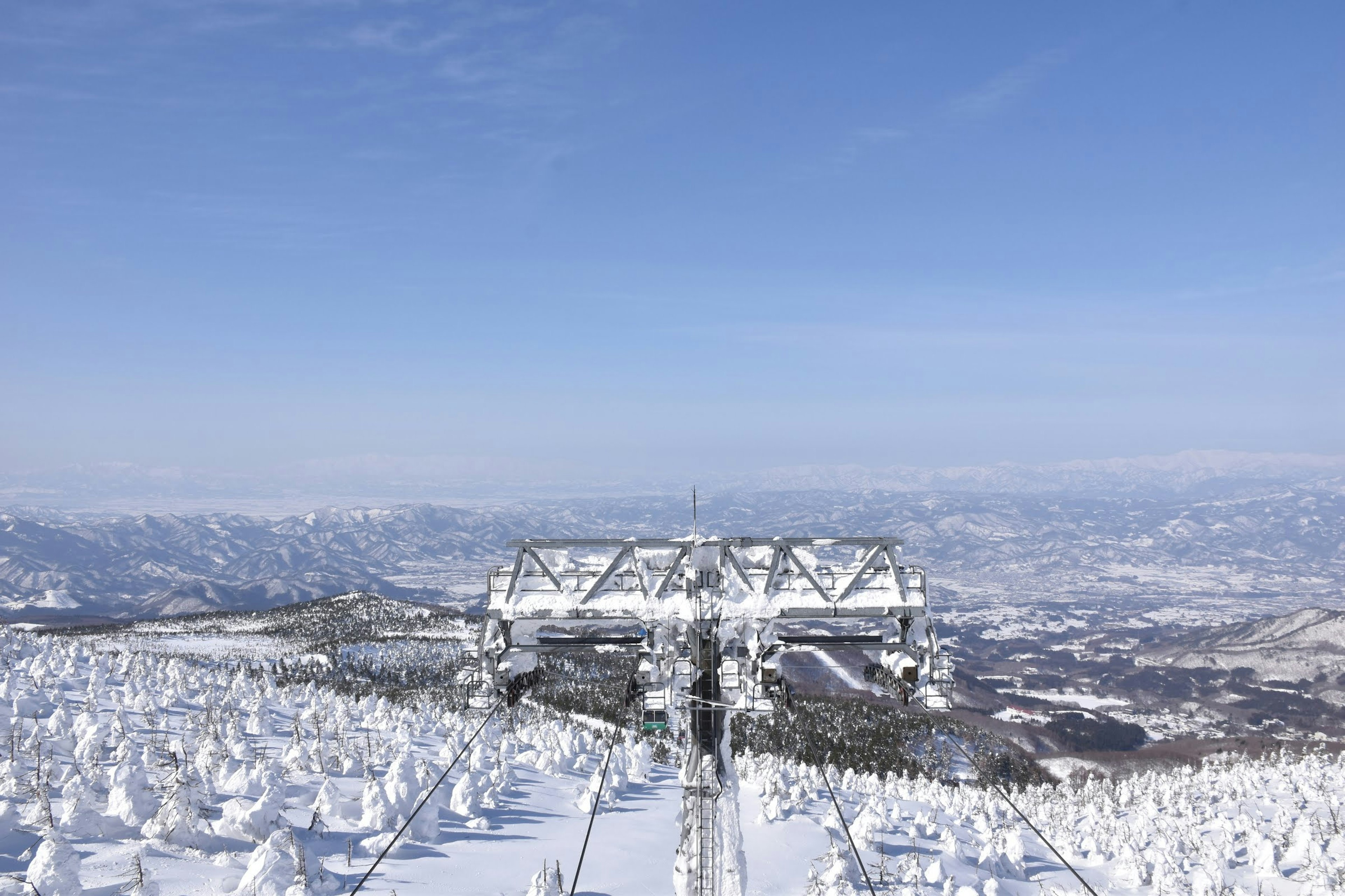 Snow-covered mountain view with ski lift structure