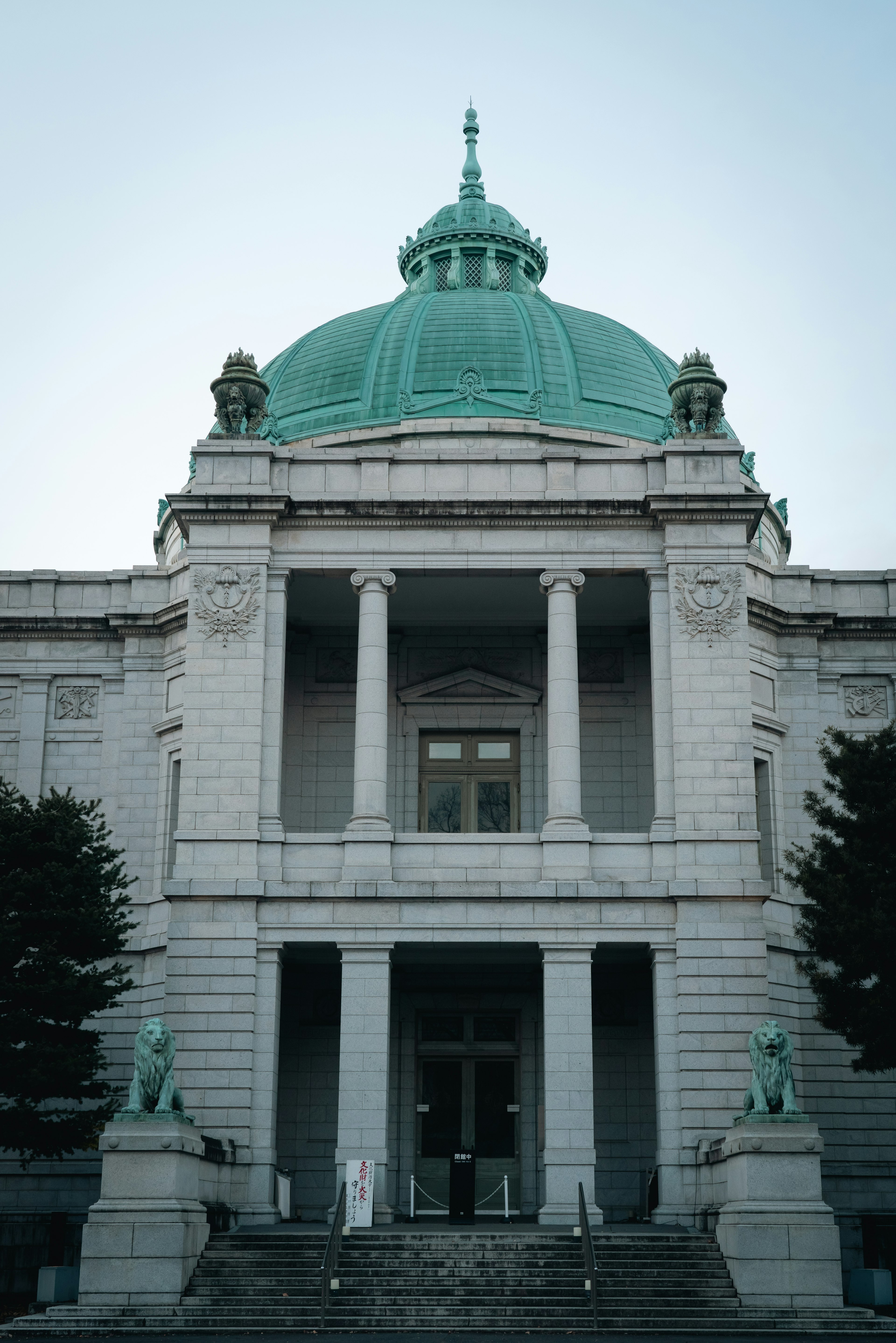 Facade of a building with a green dome and classical columns