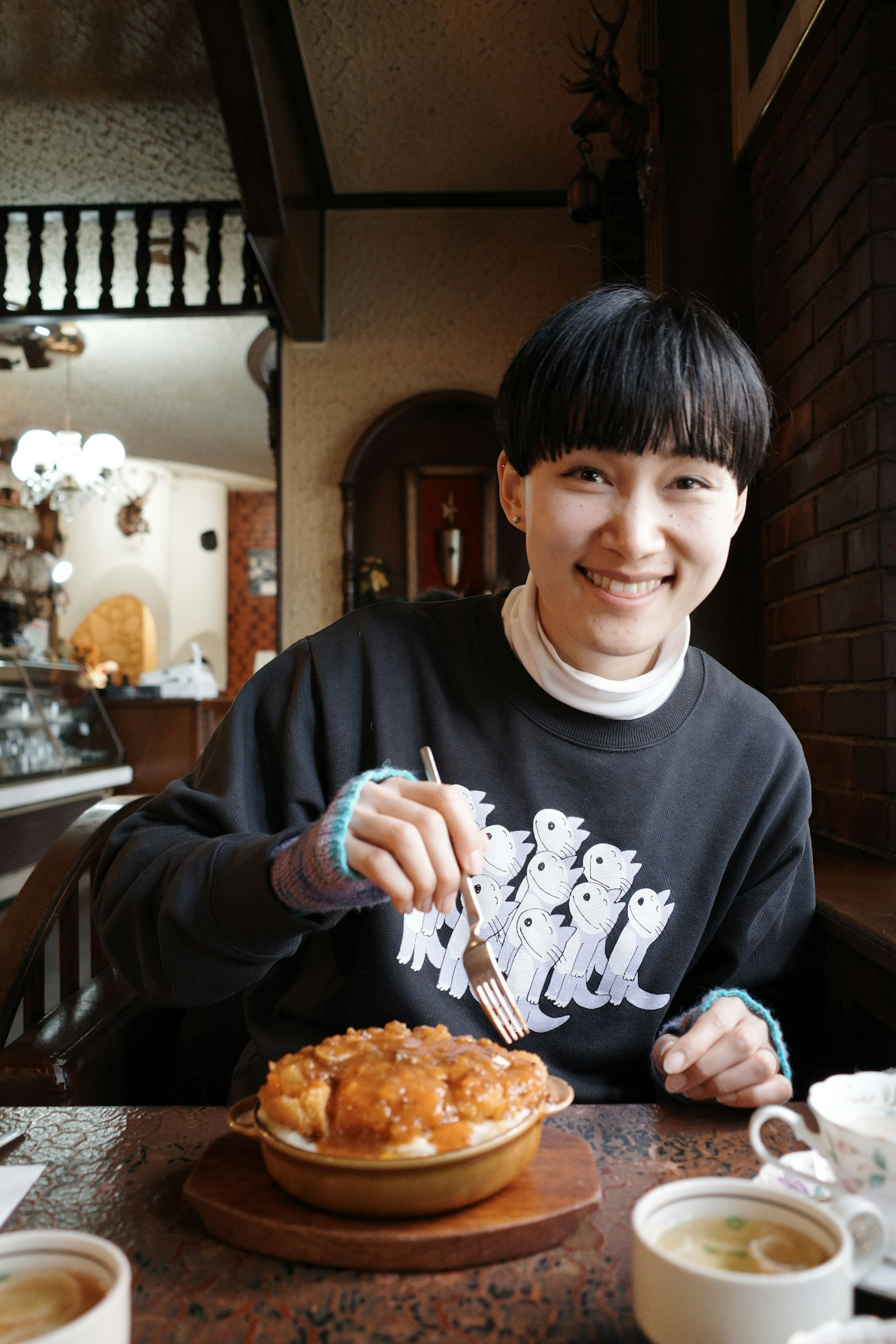 Young woman enjoying pie in a cozy café