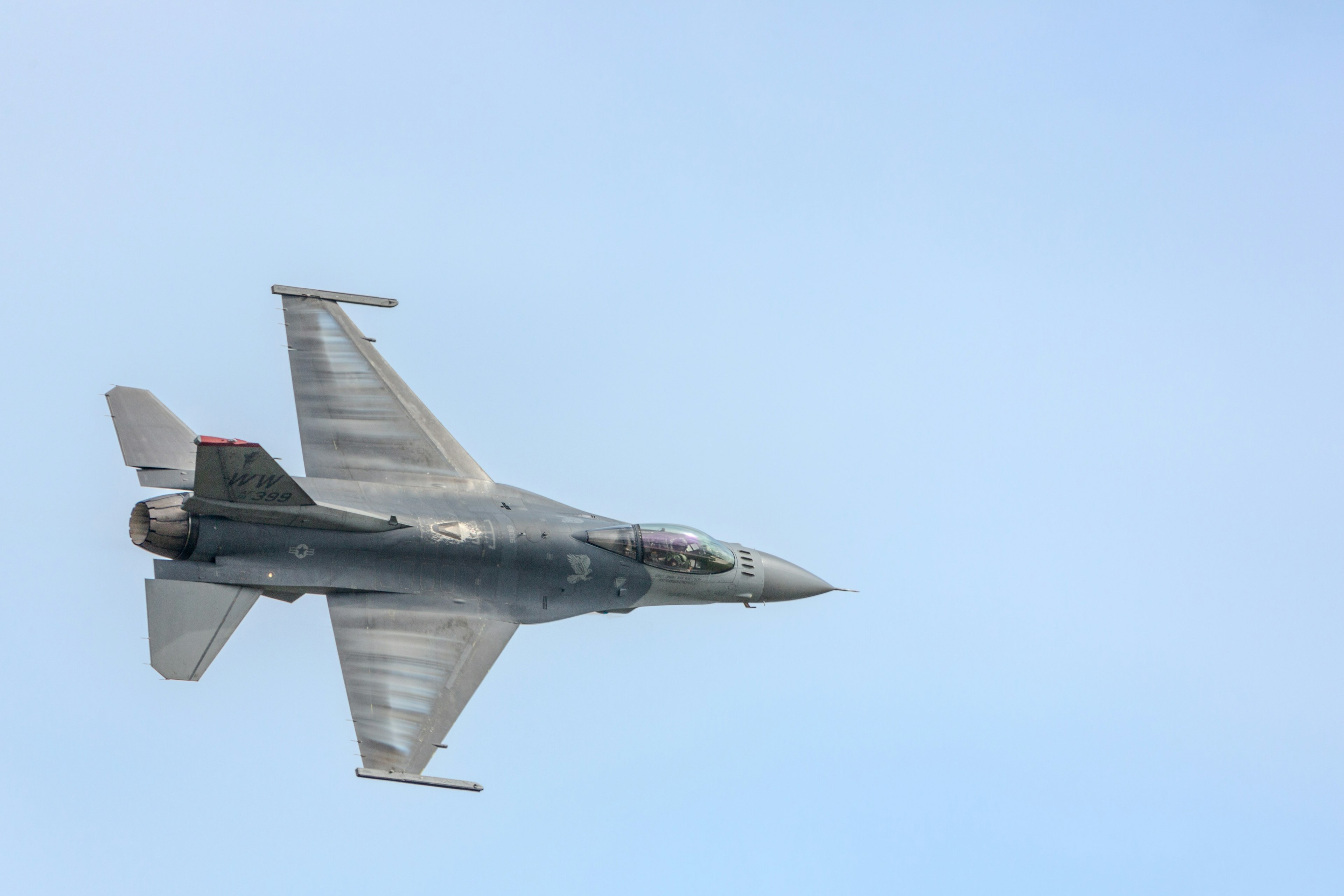 Side view of a fighter jet flying in the sky