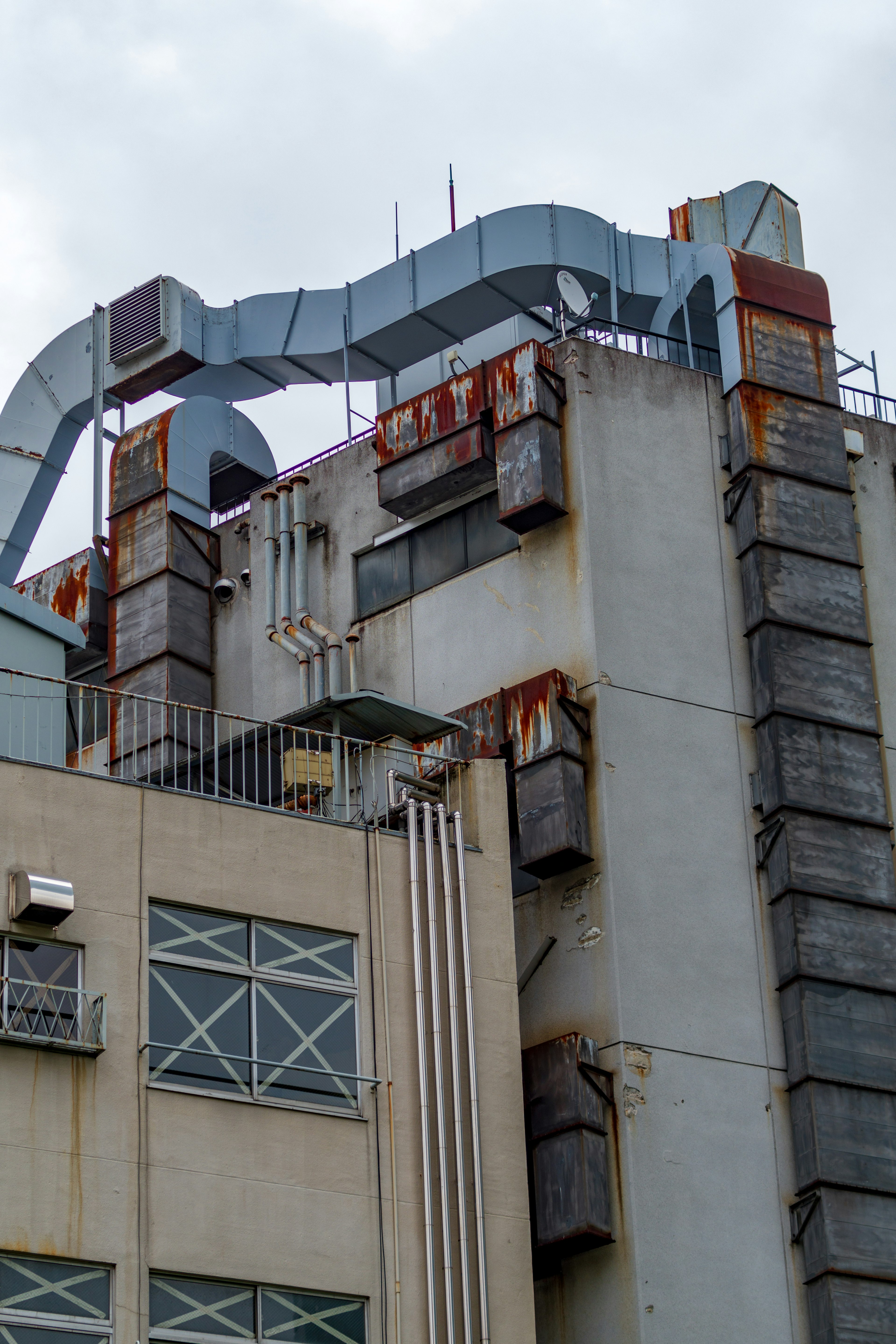 Industrial building featuring metal piping and structures on the rooftop