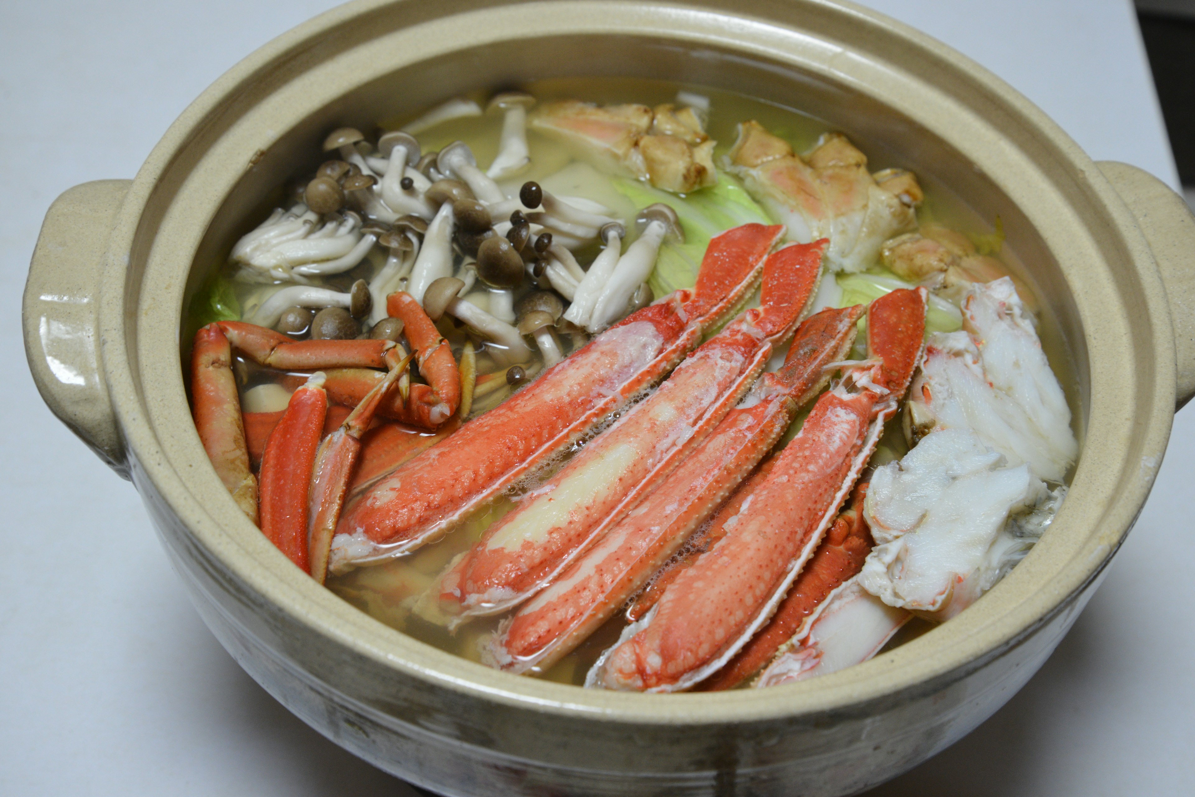 A hot pot dish featuring crab and vegetables