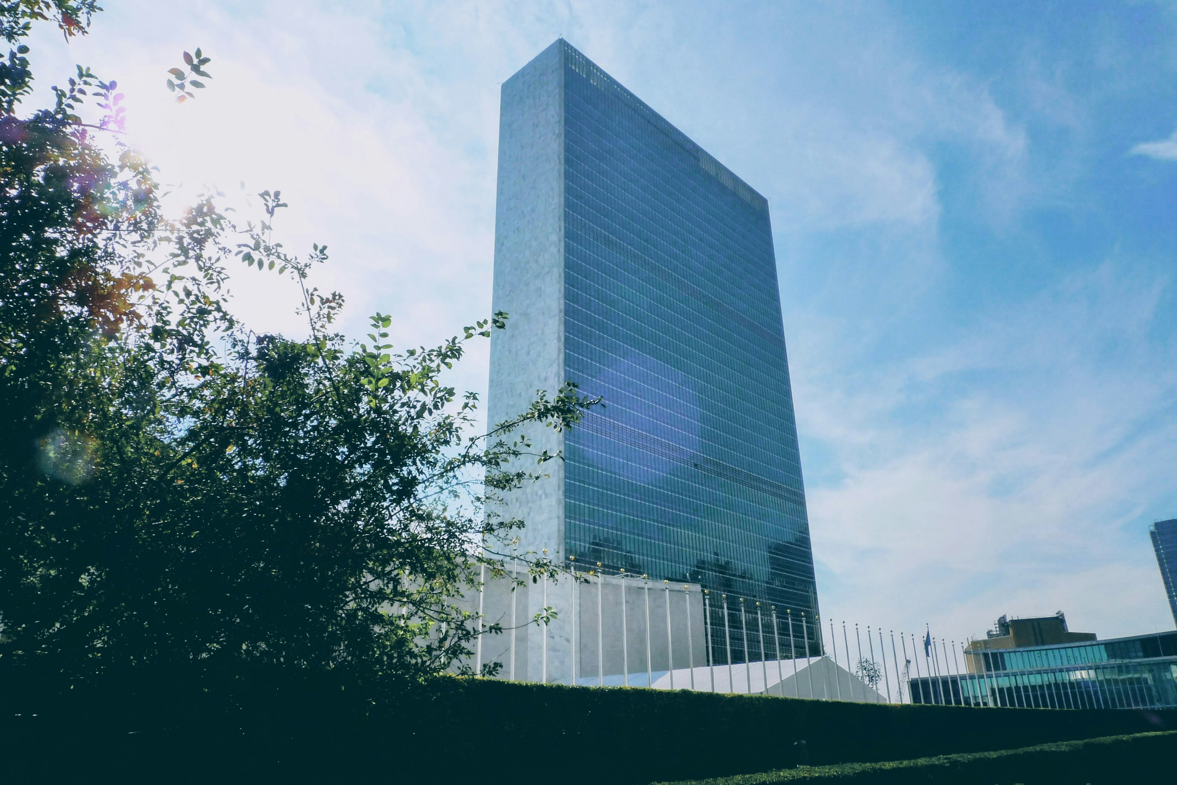 Photo of the United Nations headquarters building under a blue sky