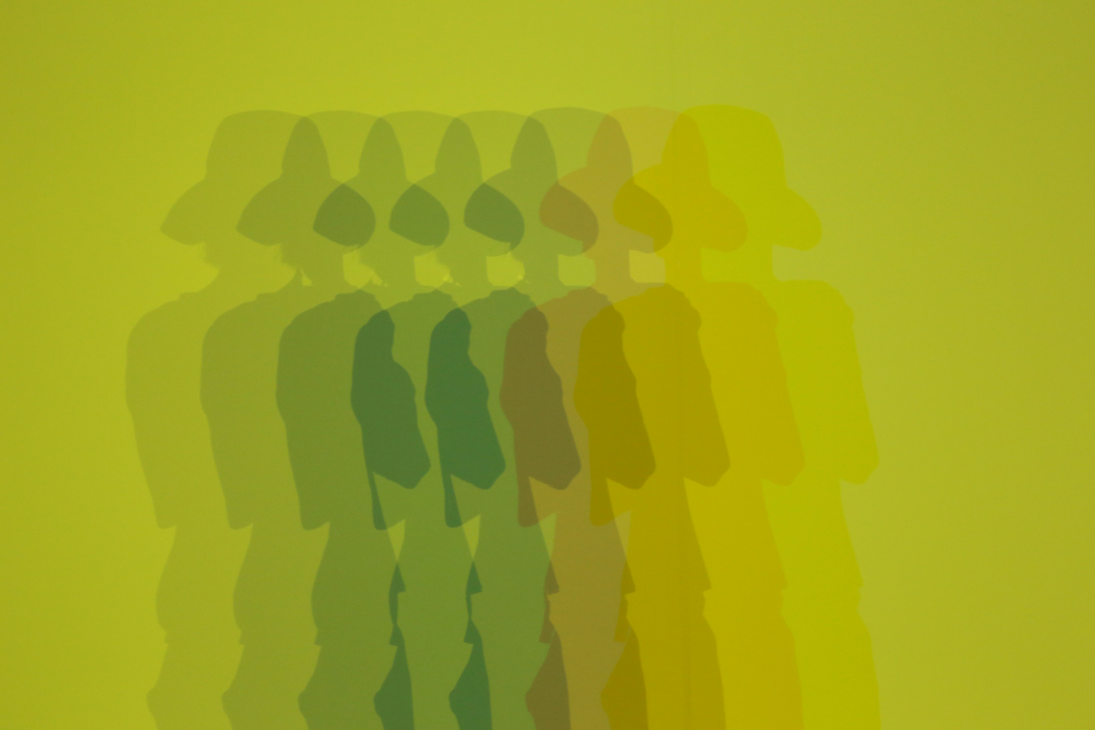 Abstract image of overlapping shadows against a green background