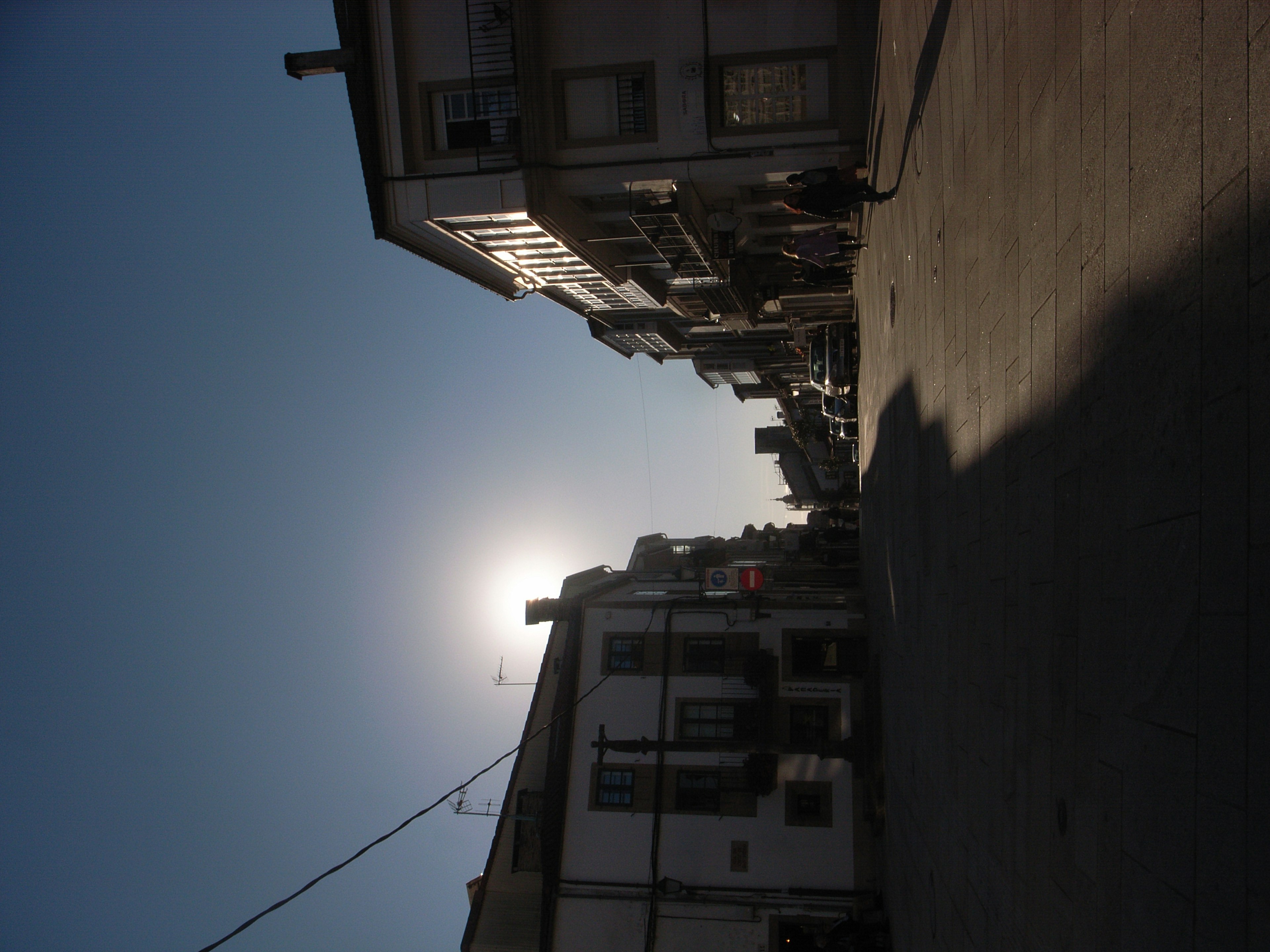 Silhouette of buildings against the sunset in a street