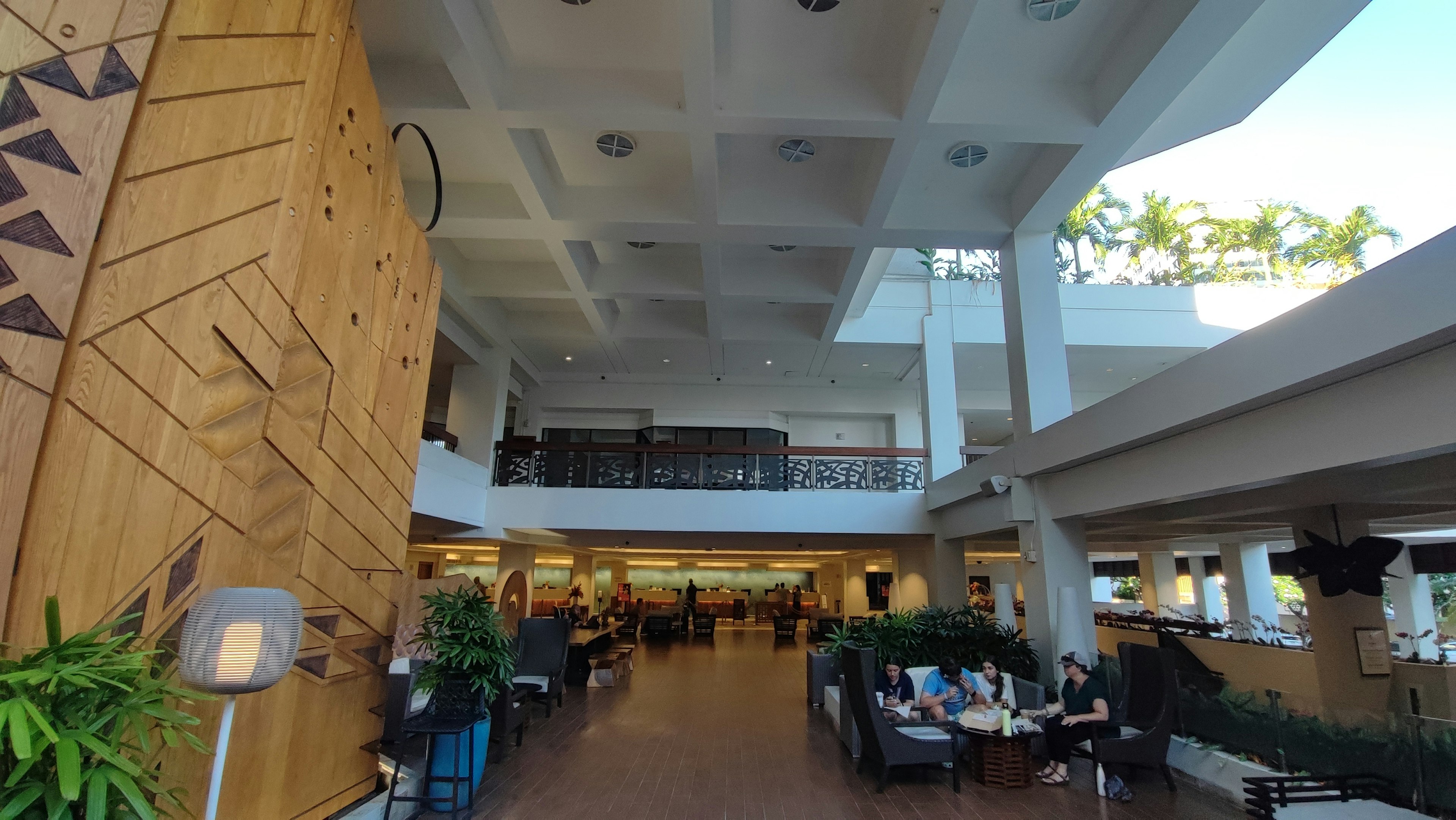 Spacious resort lobby featuring wooden decor and plants