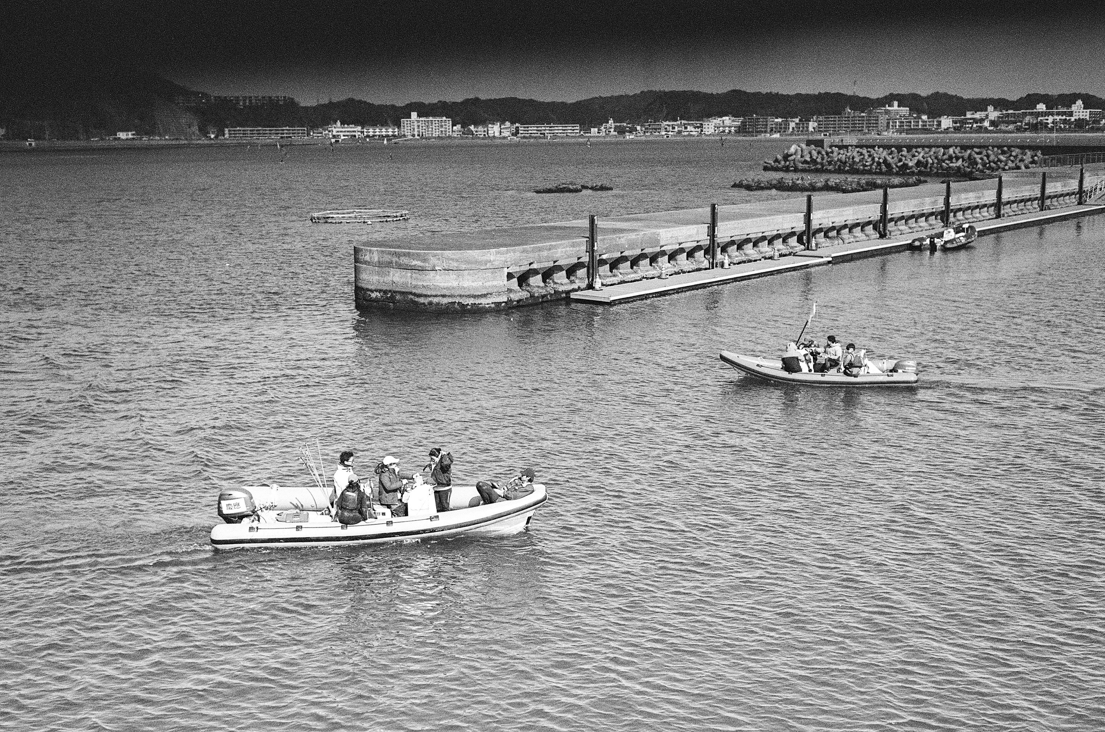 Scenic view of small boats on the water near a pier