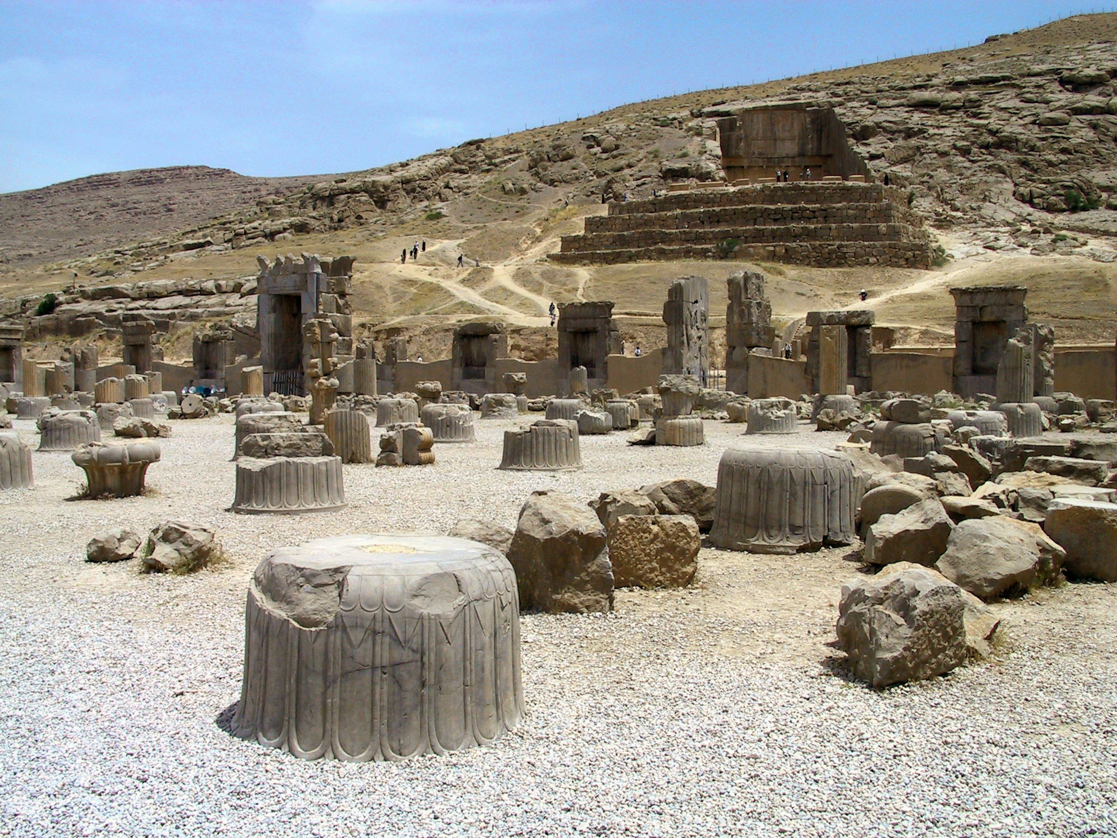 Ancient ruins featuring stone columns and rocky landscape