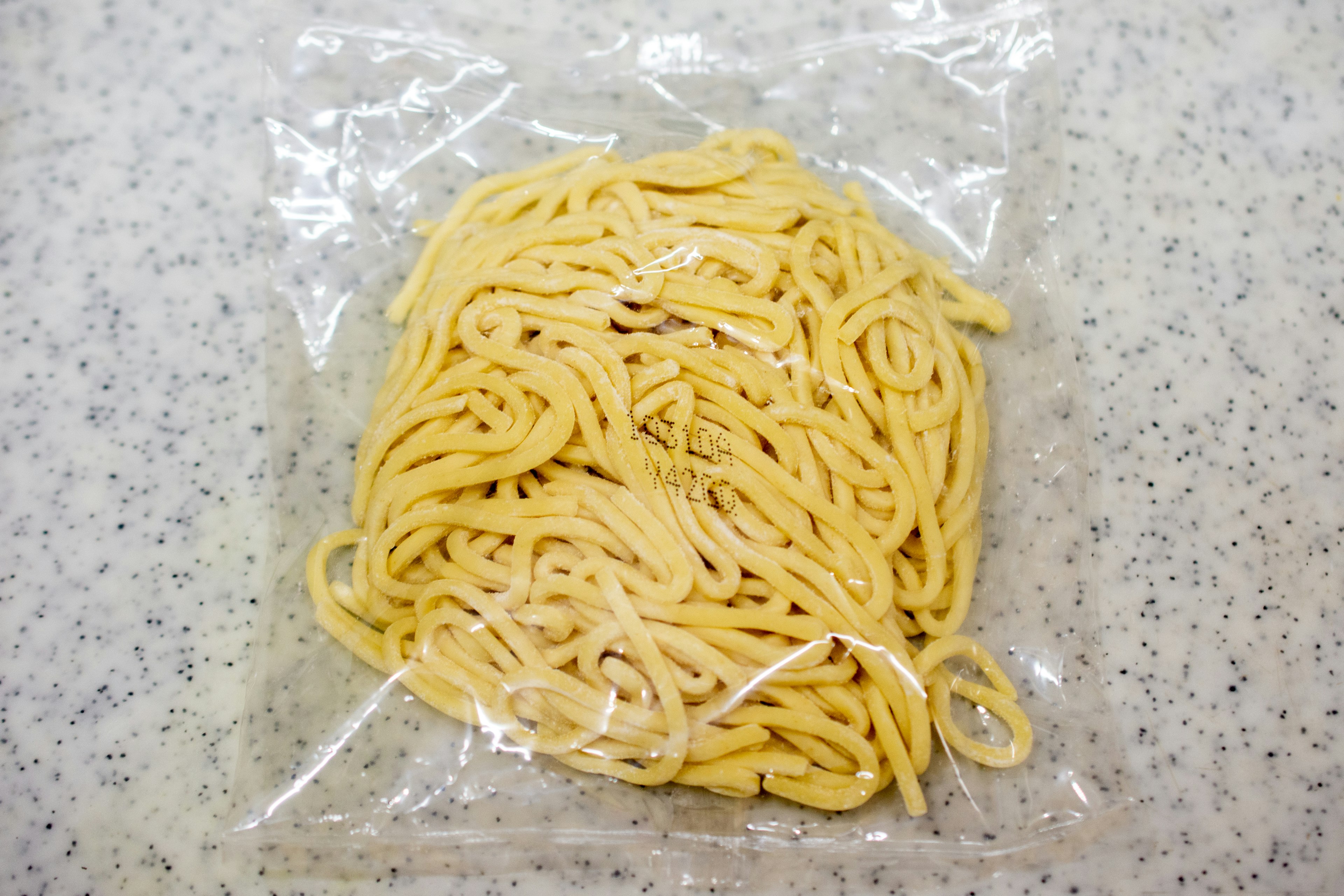 Bundle of fresh pasta in a clear plastic bag