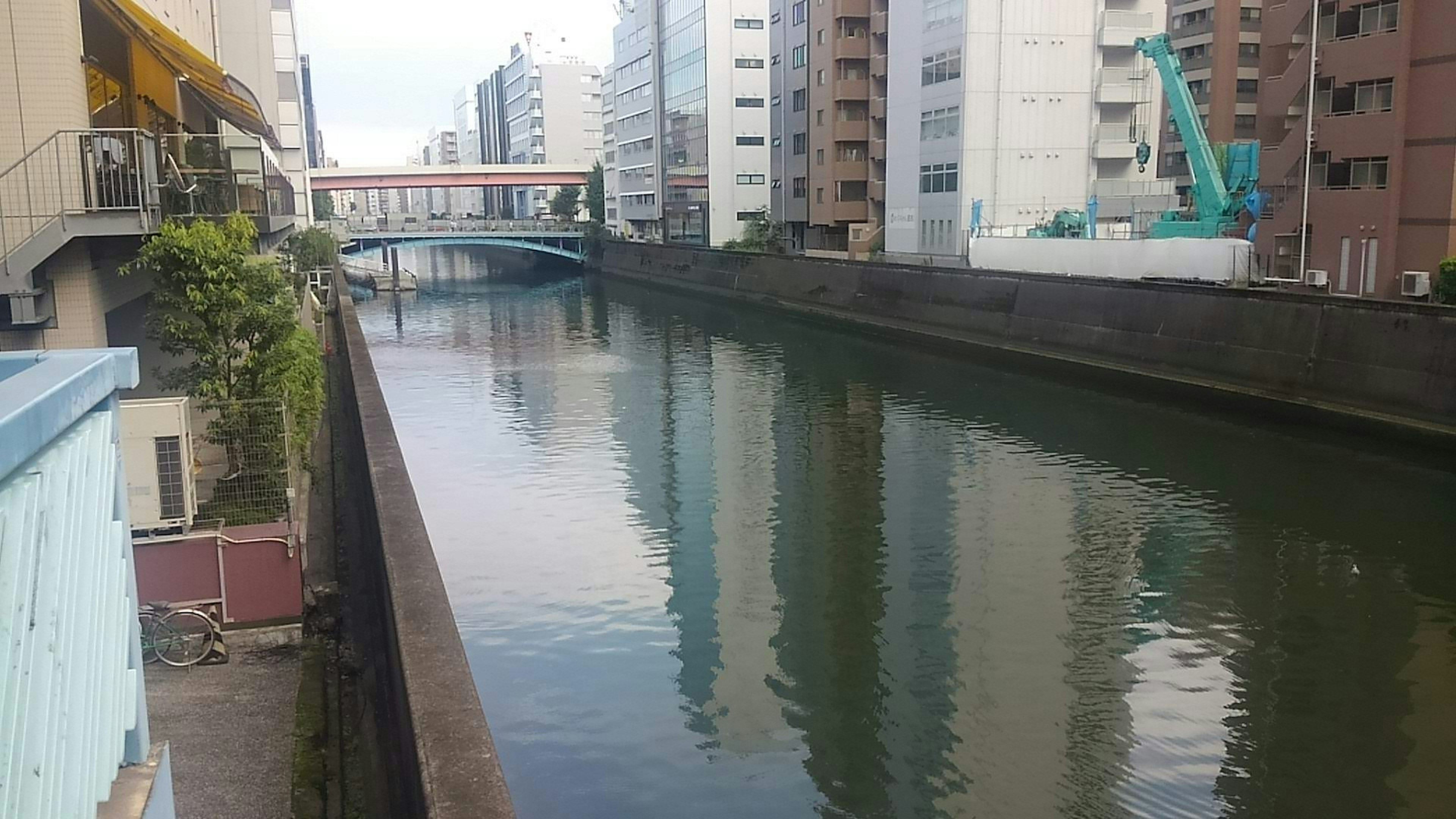 Quiet canal scene surrounded by high-rise buildings