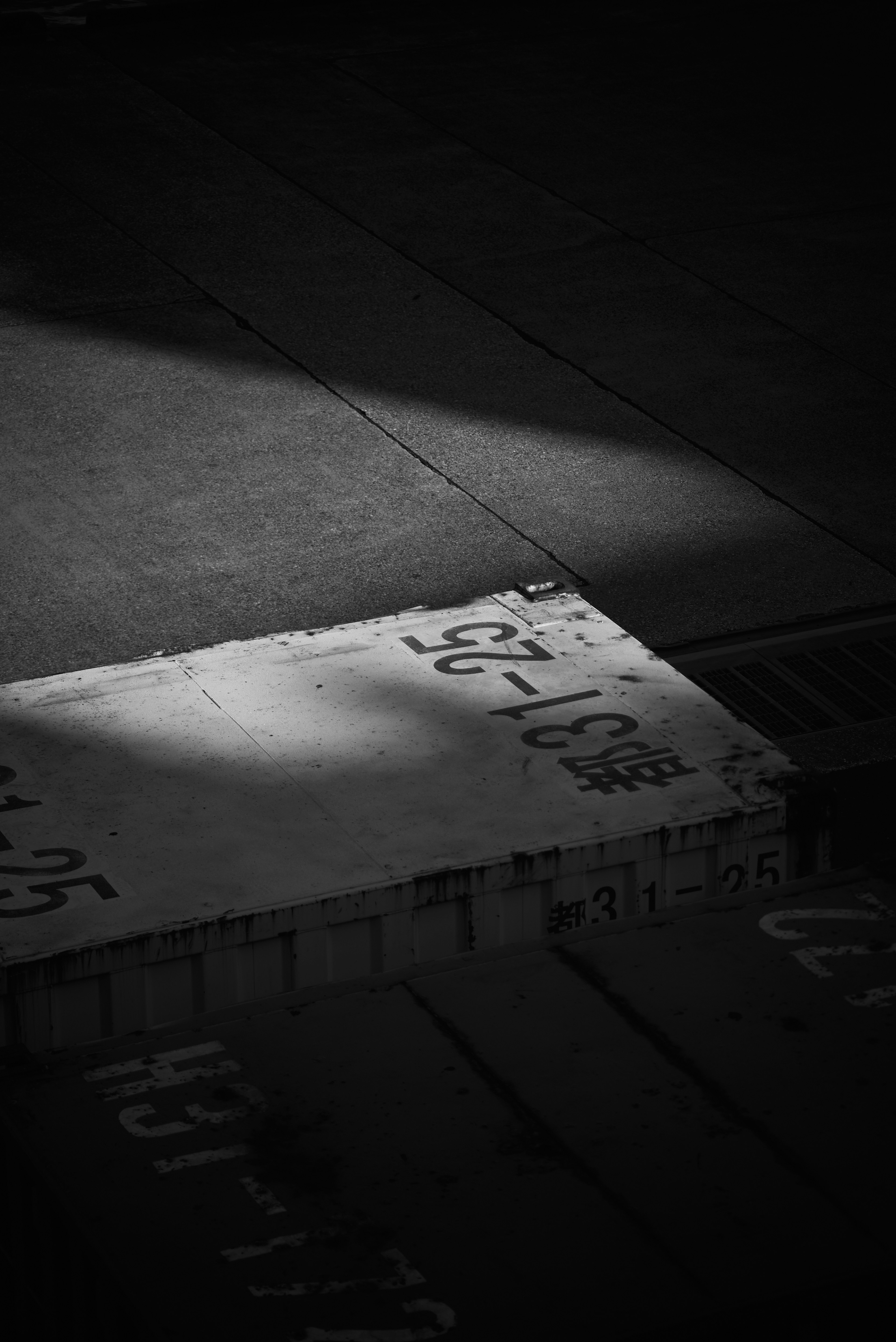 A white plate with written characters illuminated against a dark background