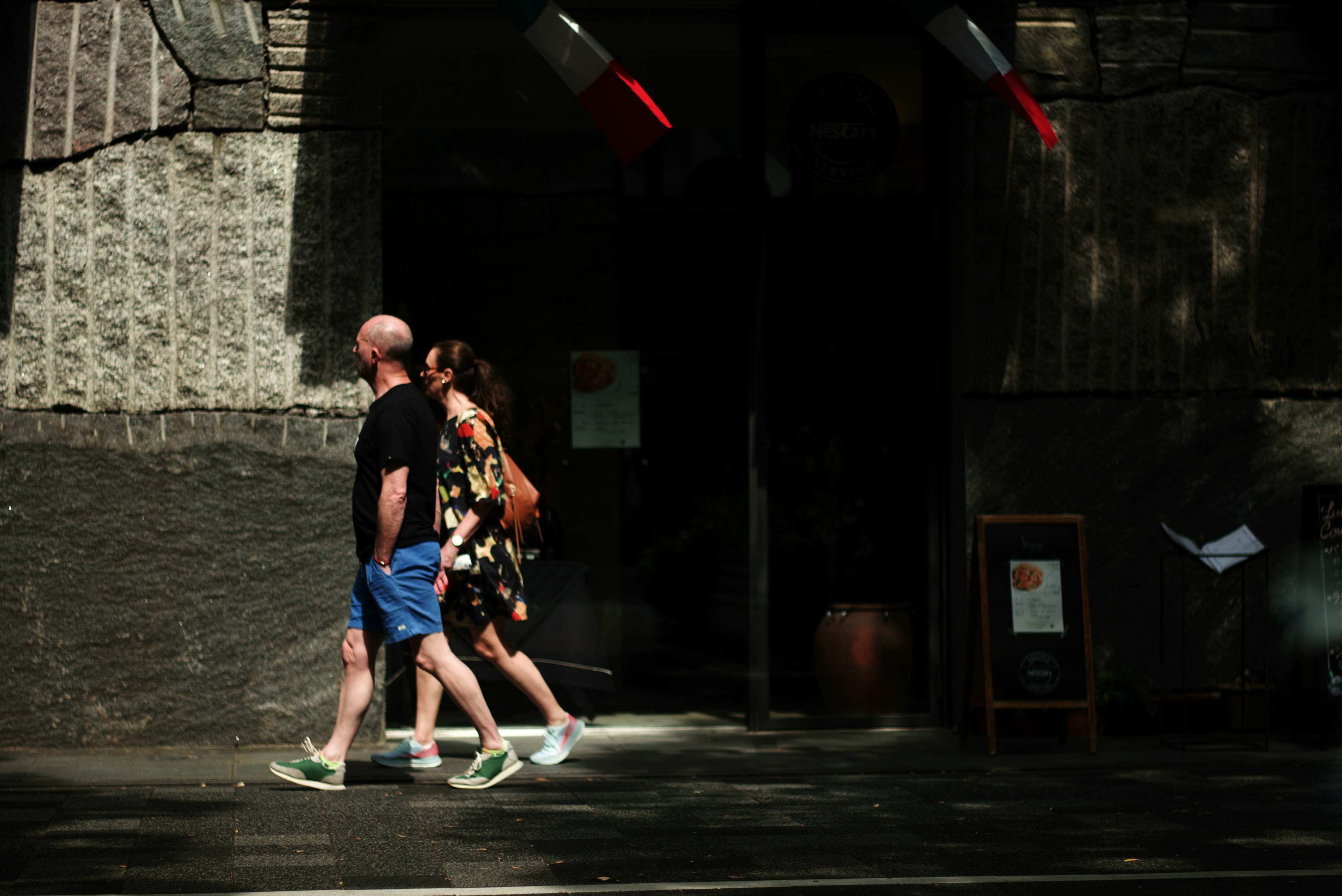 A man and a woman walking casually on the street