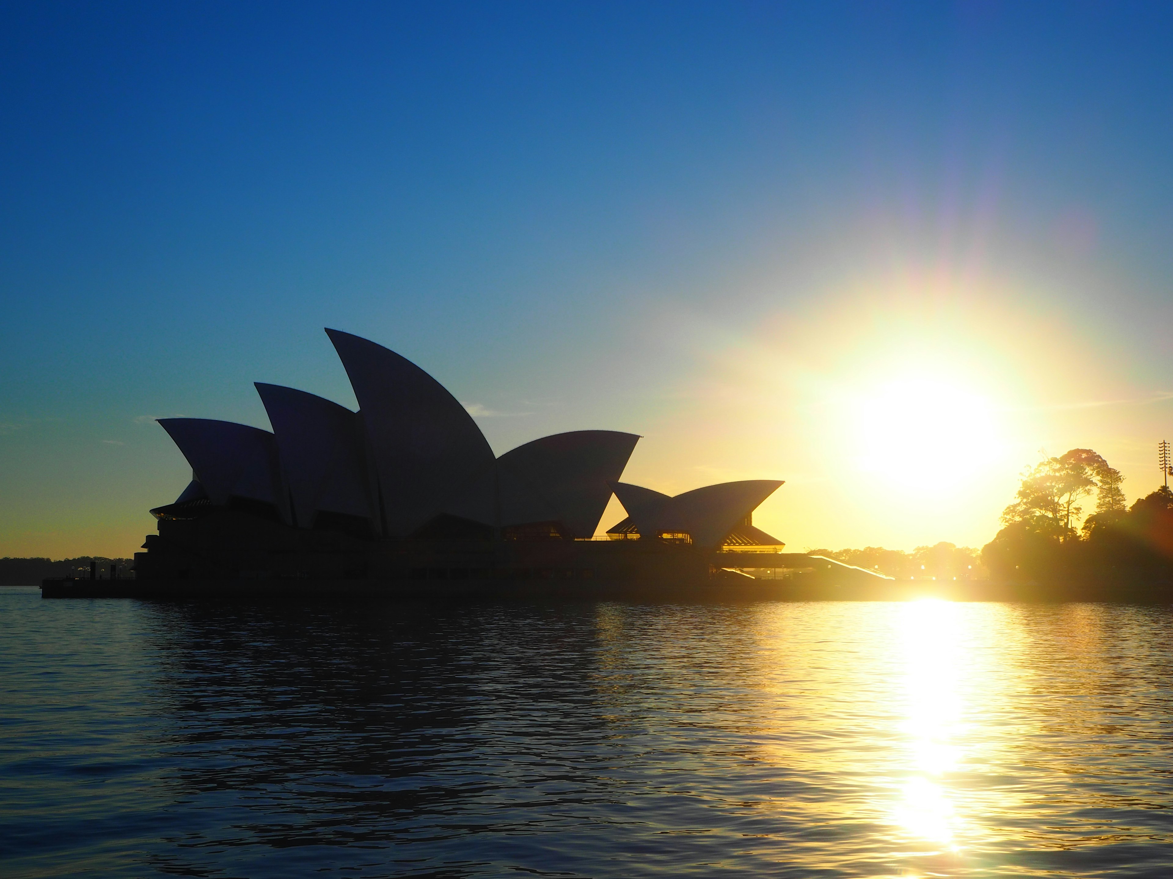 Silhouette of Sydney Opera House against sunset