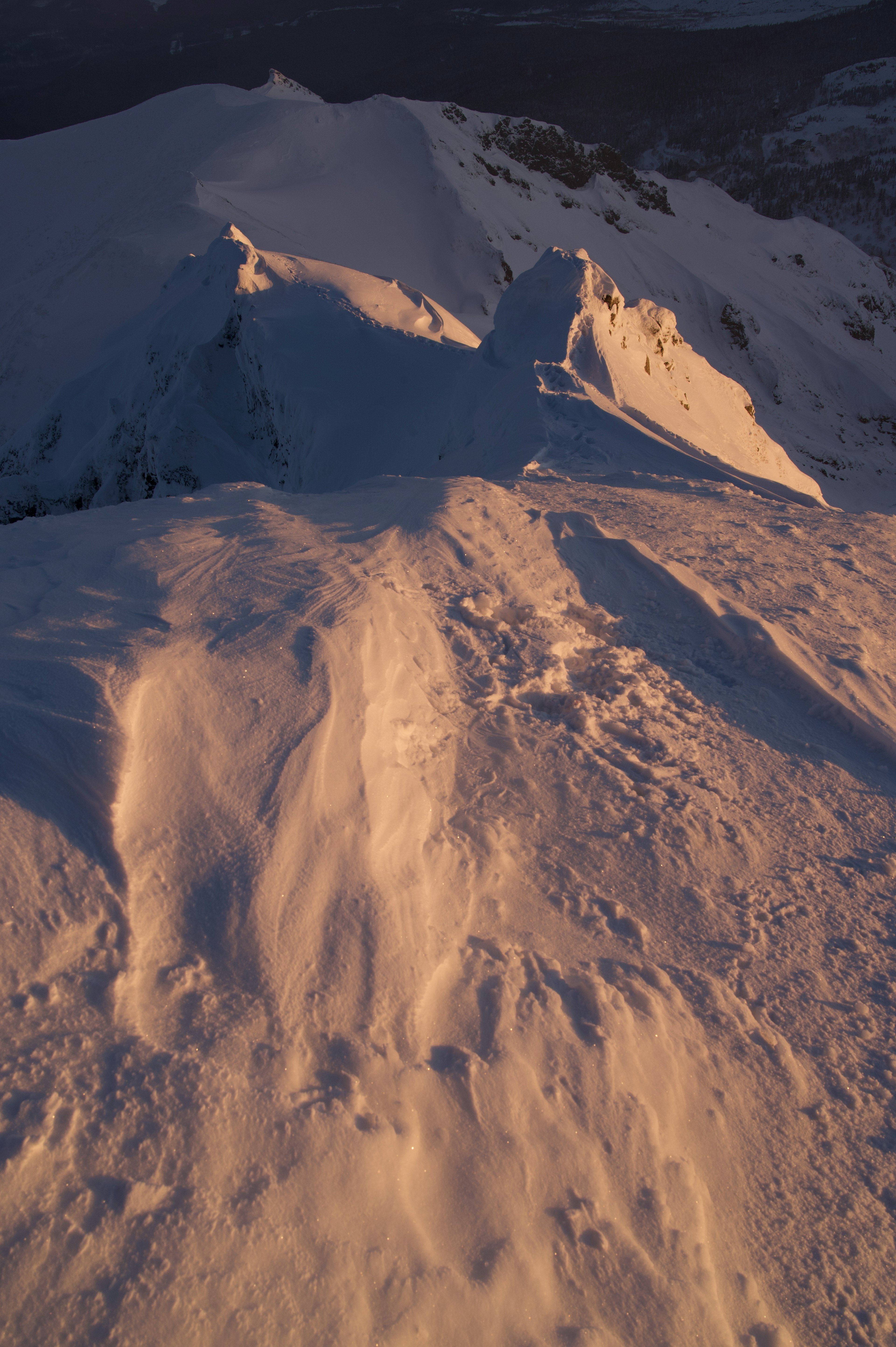 Snow-covered mountain landscape with soft evening light