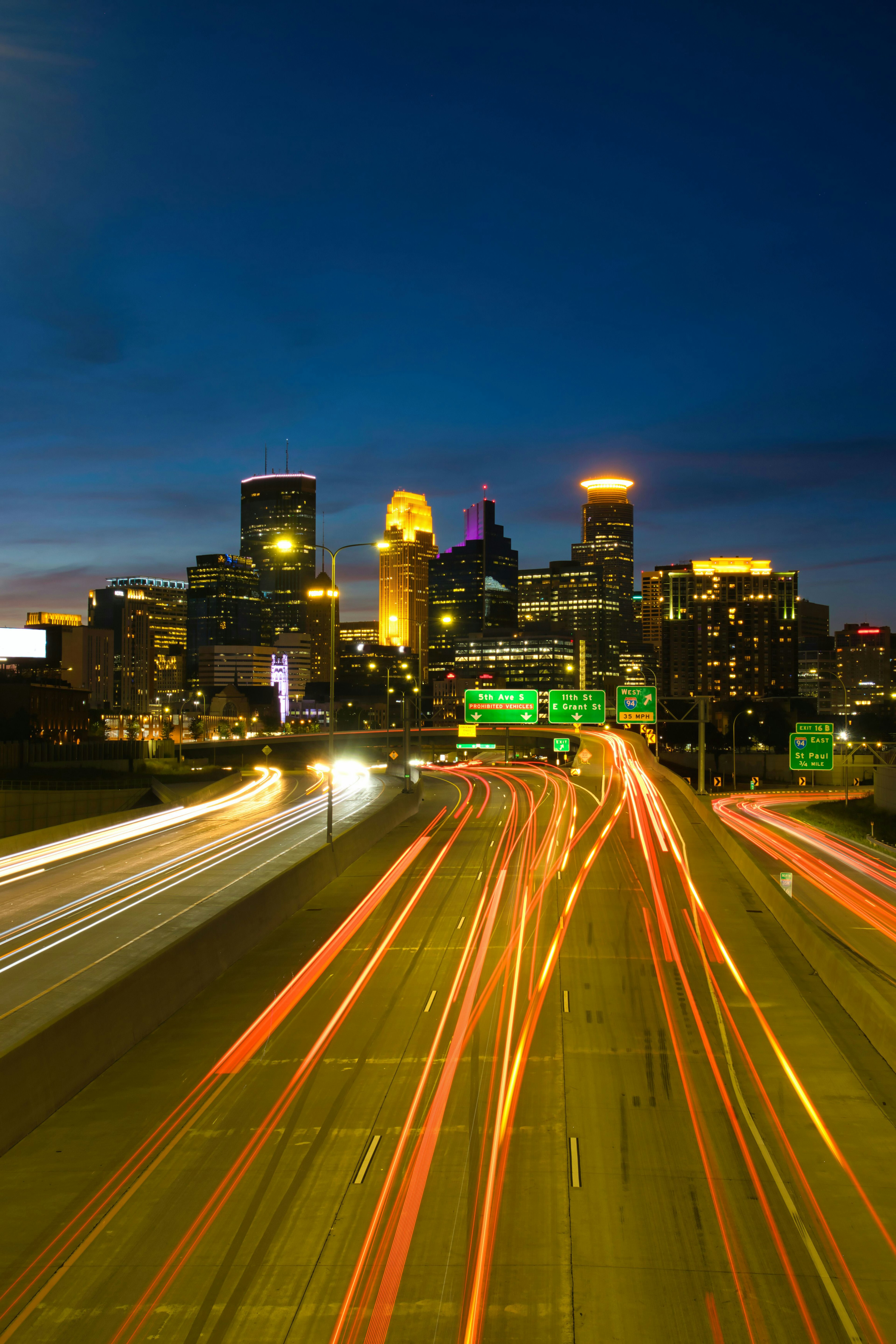 Night view of Minneapolis skyline with flowing traffic