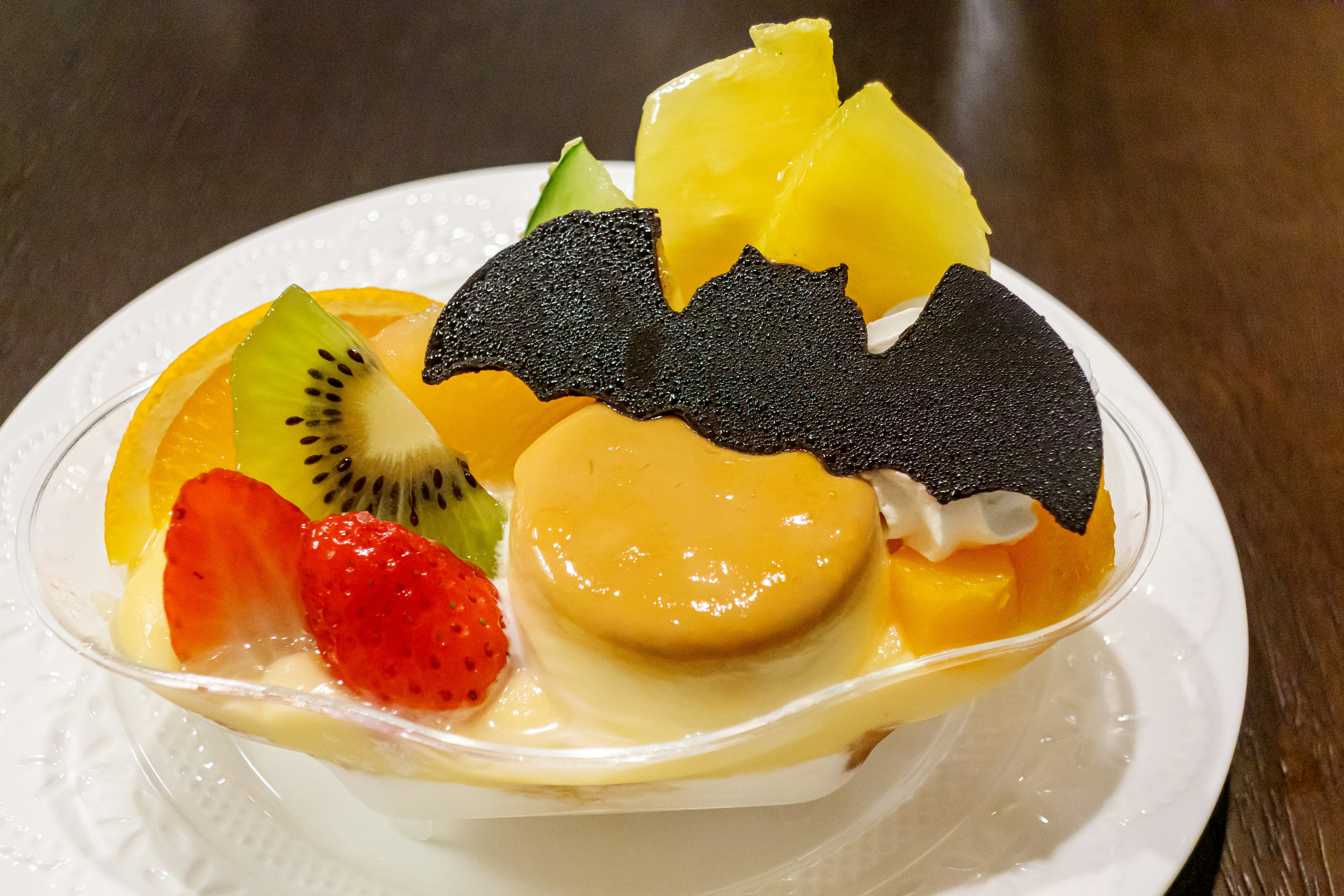 Fruit dessert topped with a bat-shaped decoration