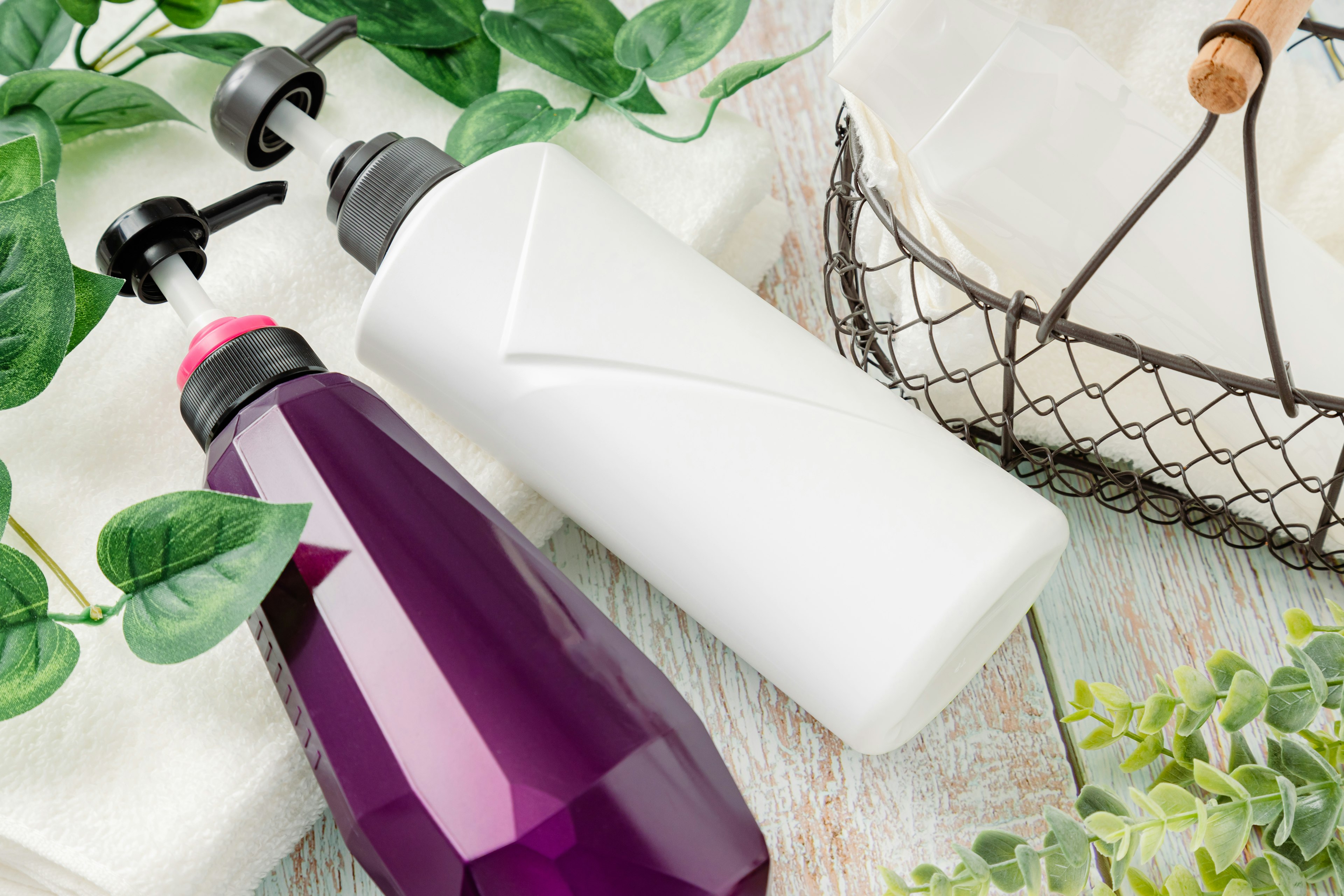 Purple and white bottles placed among greenery