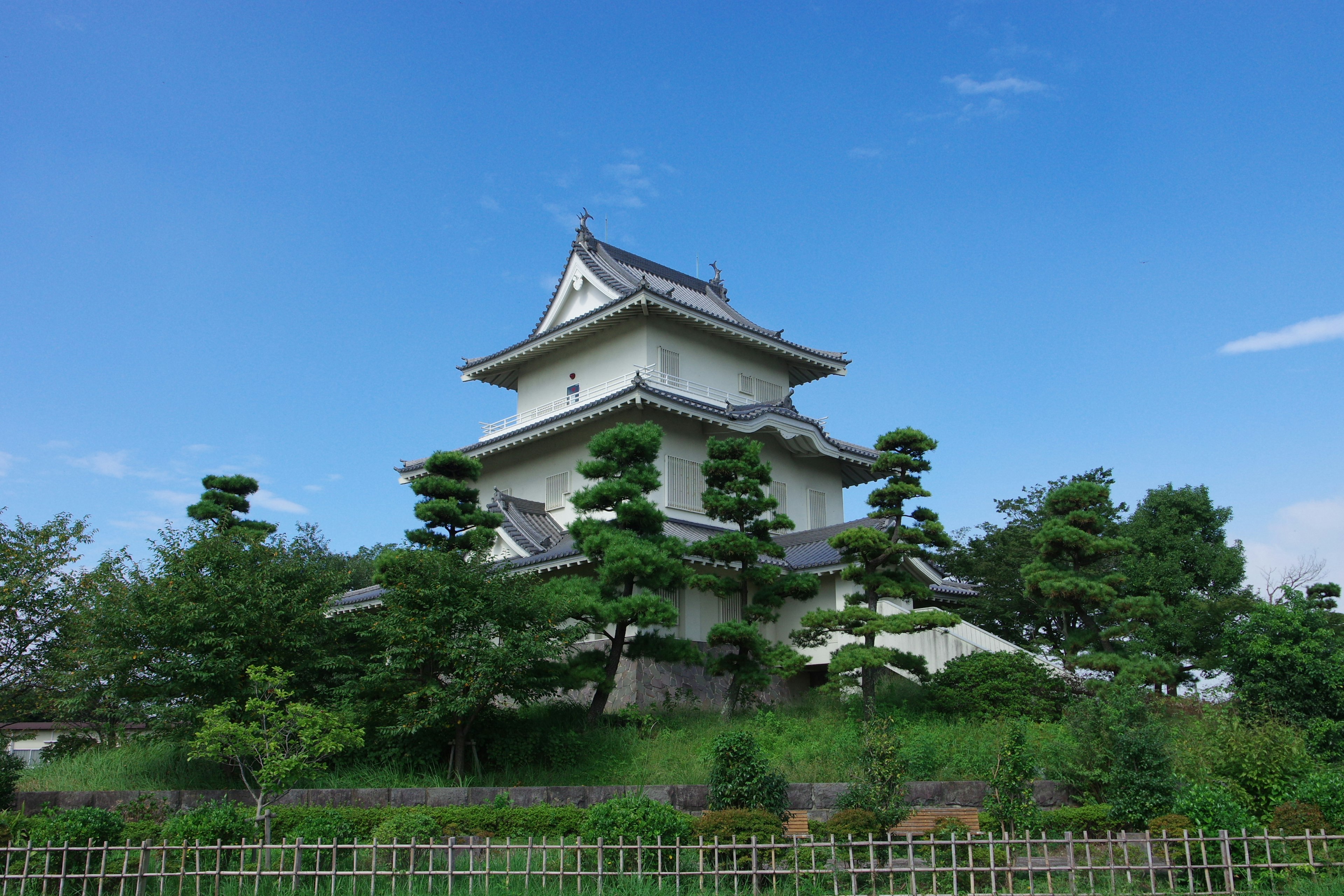 A beautiful landscape featuring a white castle surrounded by green trees