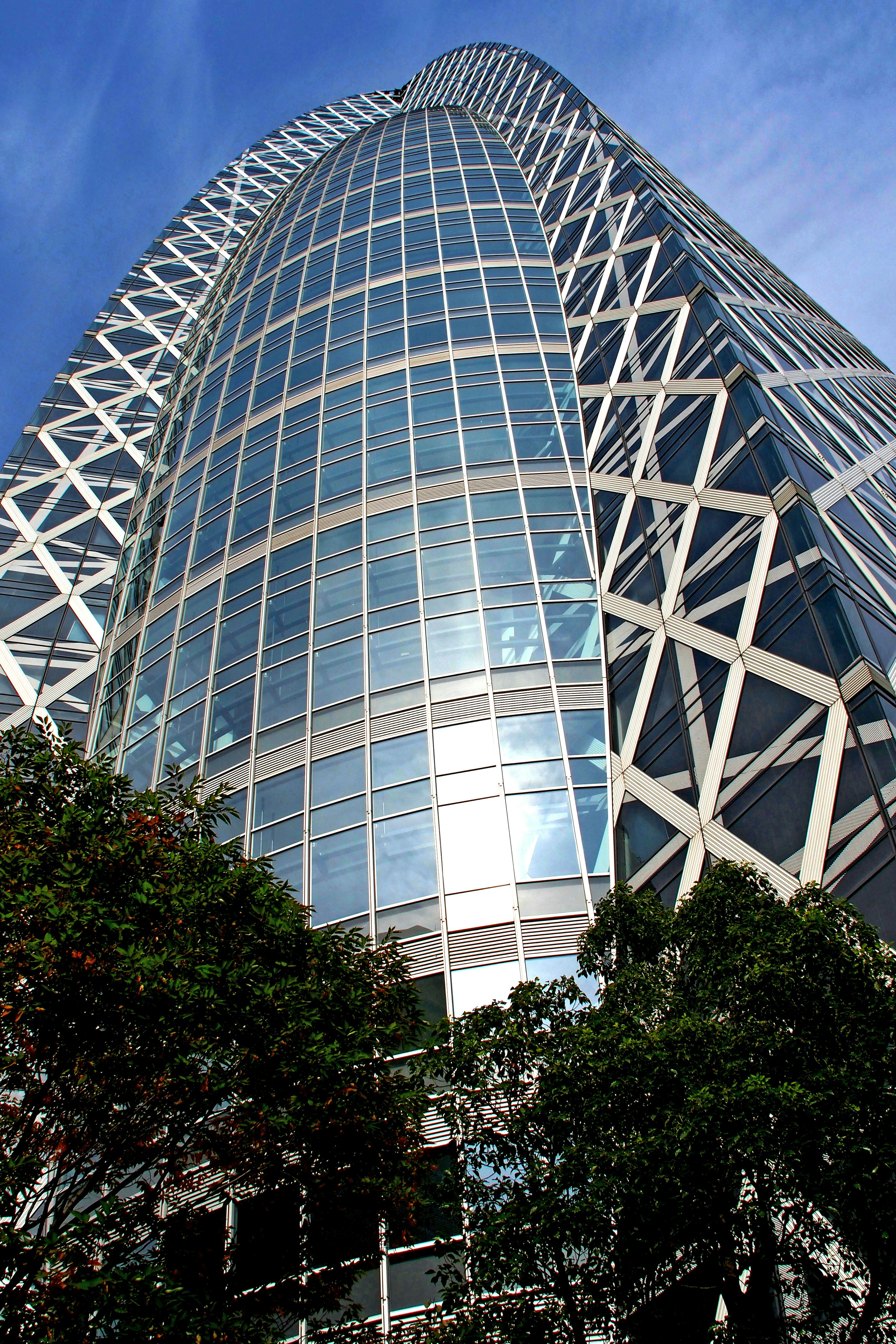 Futuristic design of a skyscraper with a blue sky background