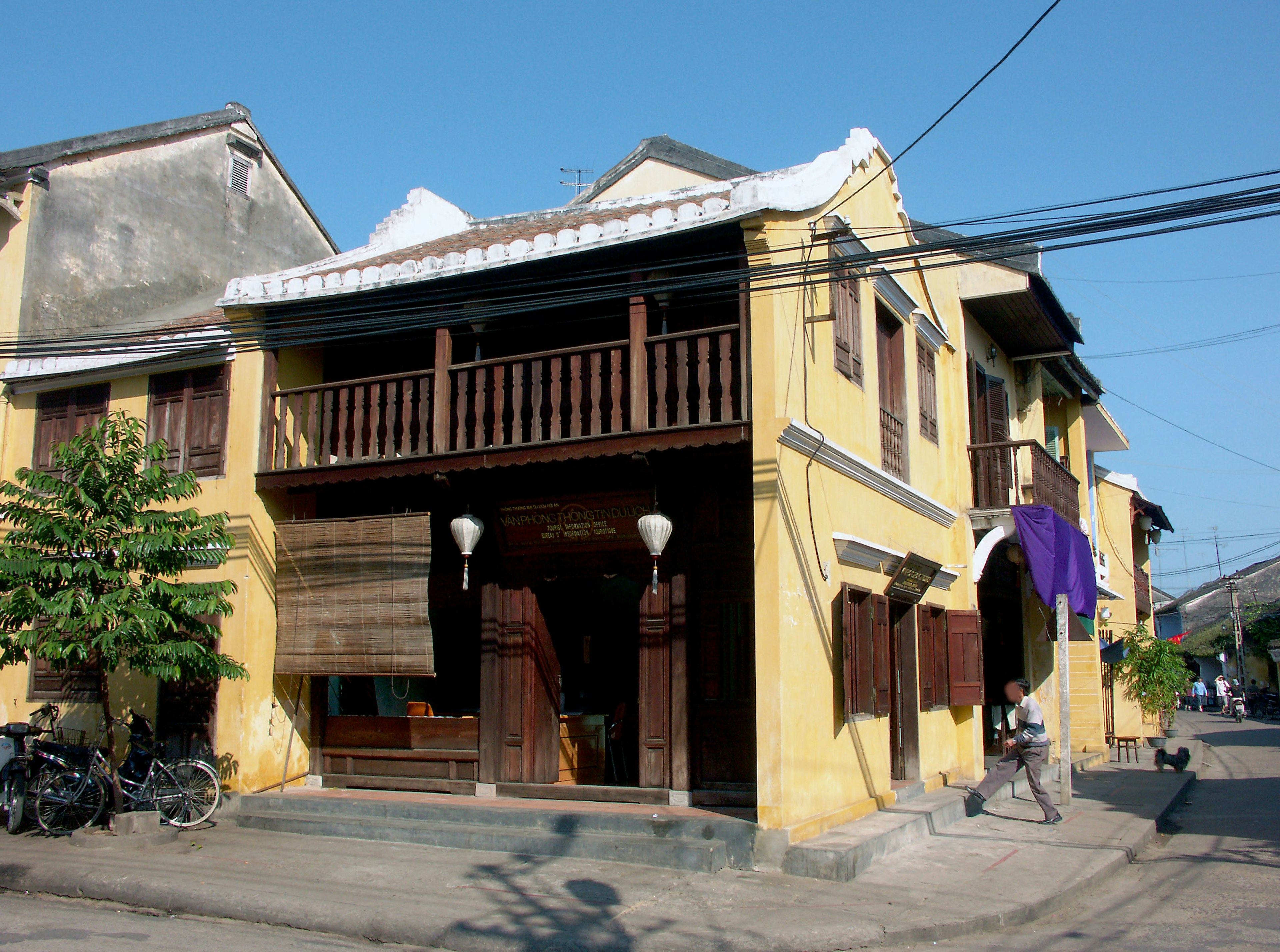 Traditional house with yellow exterior and balcony