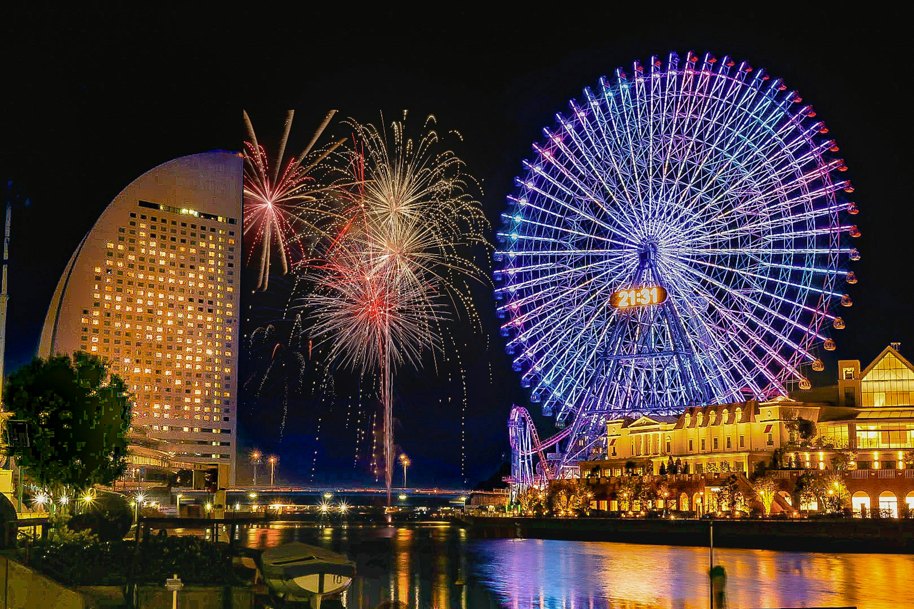 Bunte Feuerwerke erhellen den Nachthimmel über einem Riesenrad in Yokohama